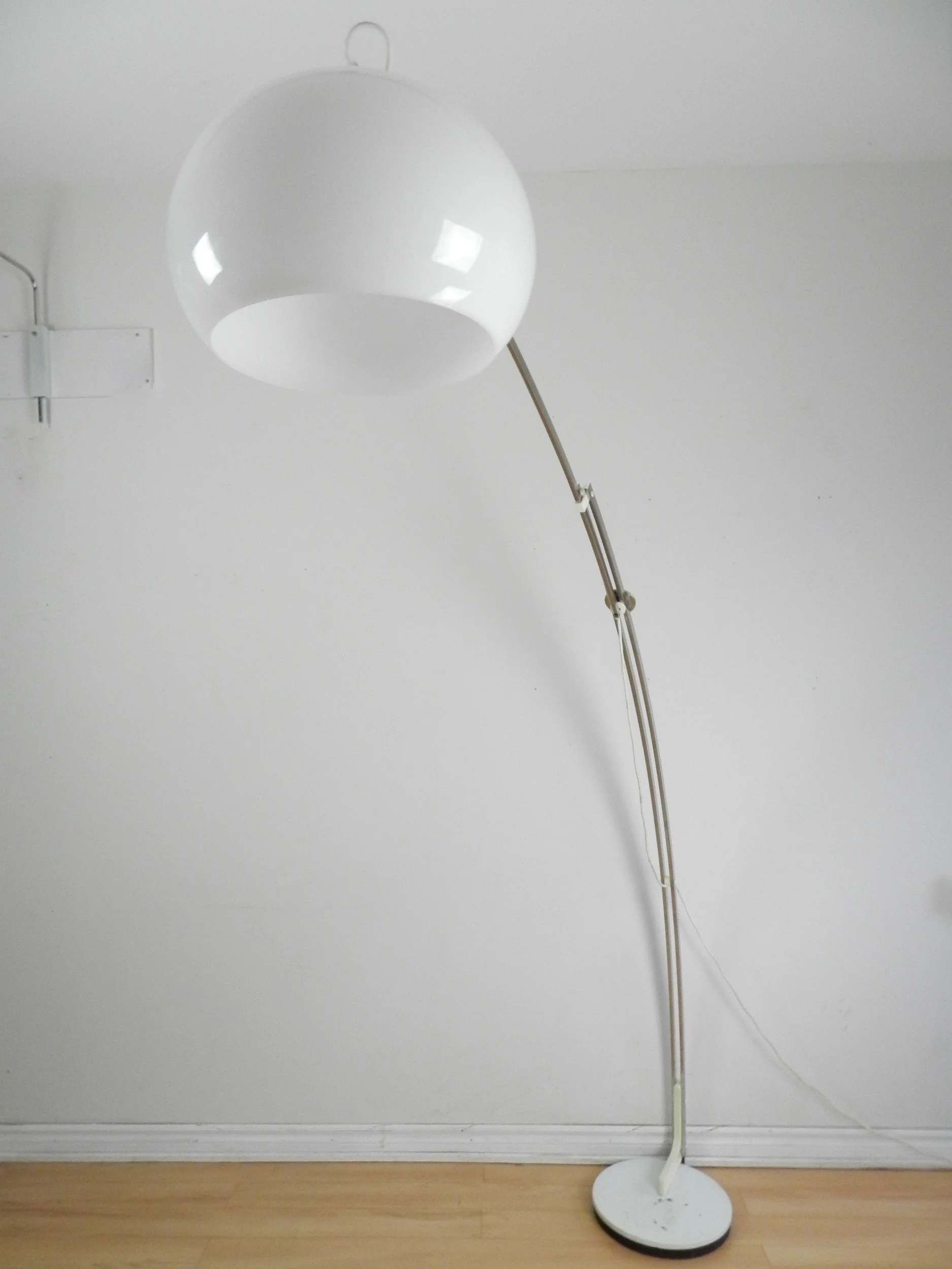 Adjustable arc lamp in chrome with acrylic shade by Reggiani.  Italy, 1970s.