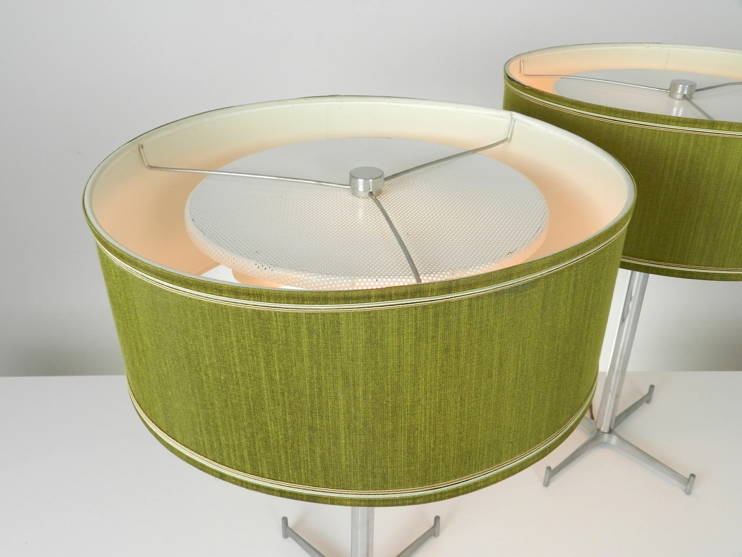 Pair of mid century chrome lamps with cast aluminum bases and original shades. Created by Electrohome.  Canada, 1960s.