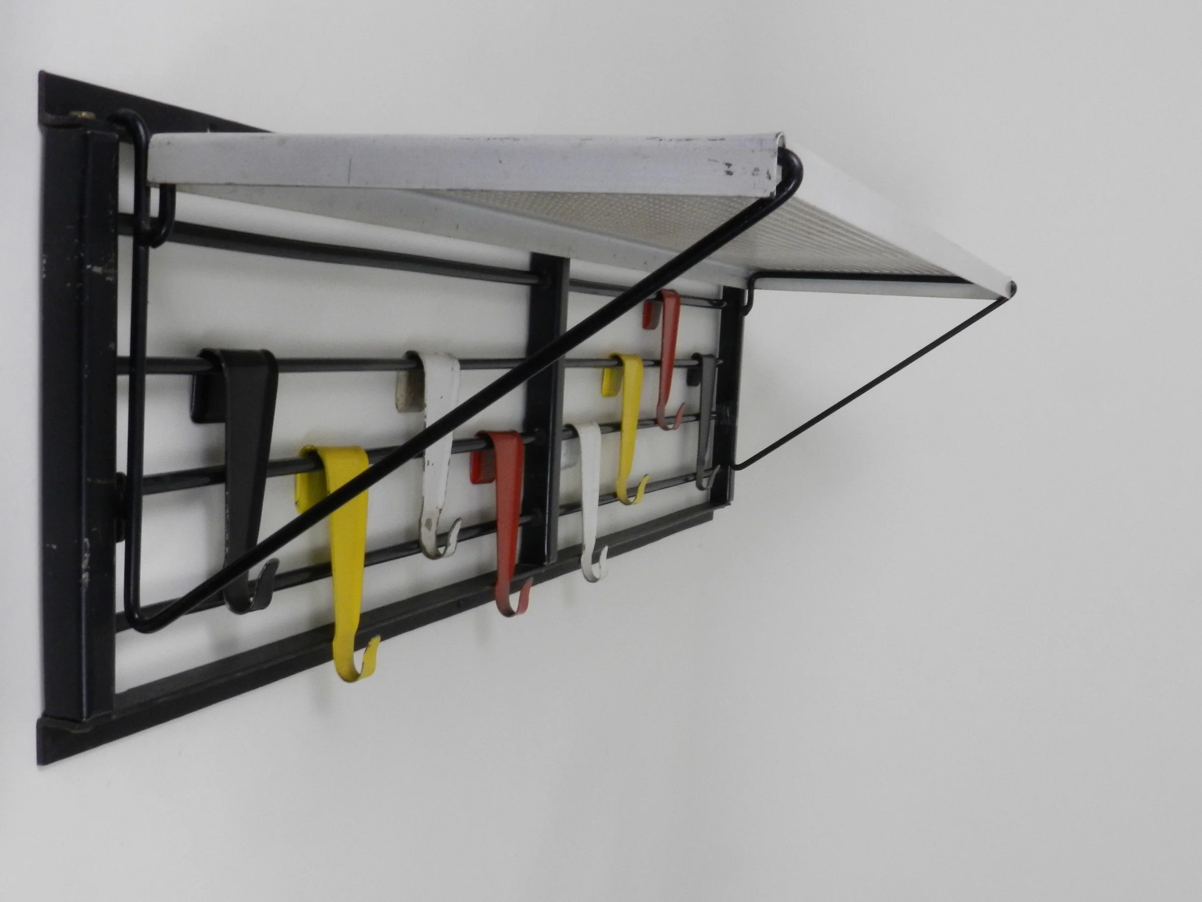 Mid century modern wall mounted coat rack designed by Tjerk Reijenga for Pllastro.  Netherlands, 1950s.