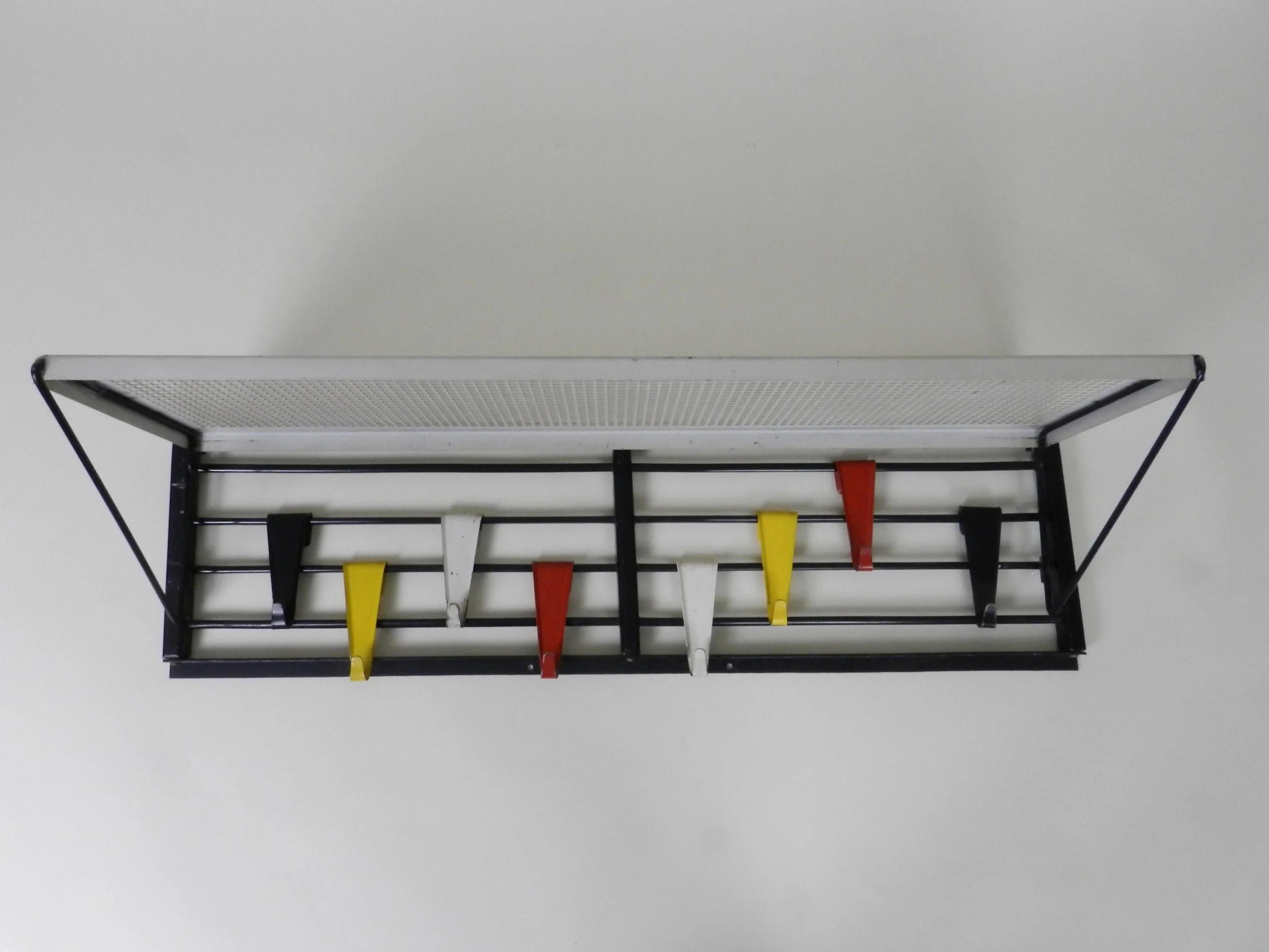 Mid century modern wall mounted coat rack designed by Tjerk Reijenga for Pllastro.  Netherlands, 1950s.