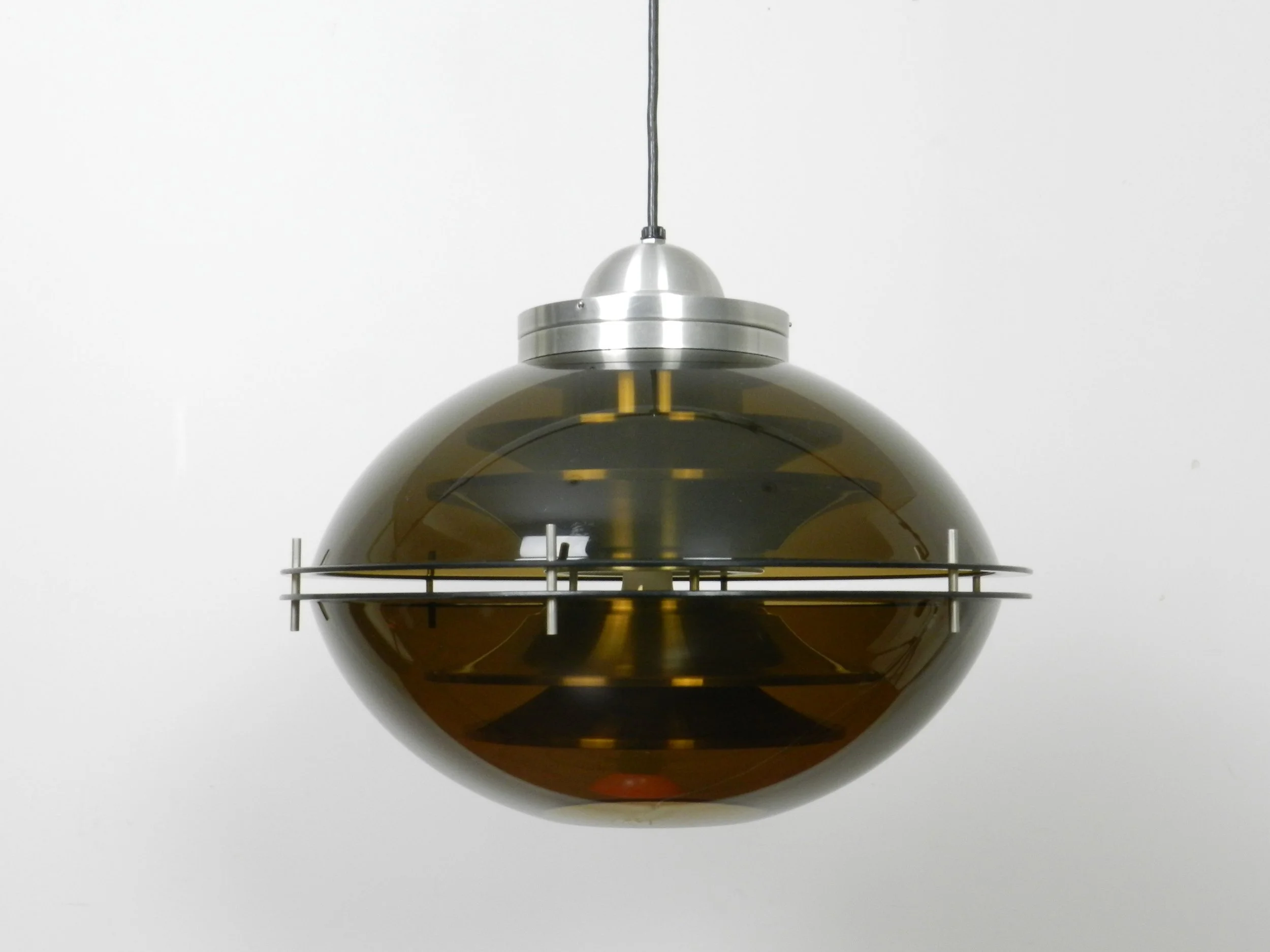 Space age pendant lamp with tinted acrylic outer shell and stacked aluminum plates on the interior by Herda.  Netherlands, 1970s.
