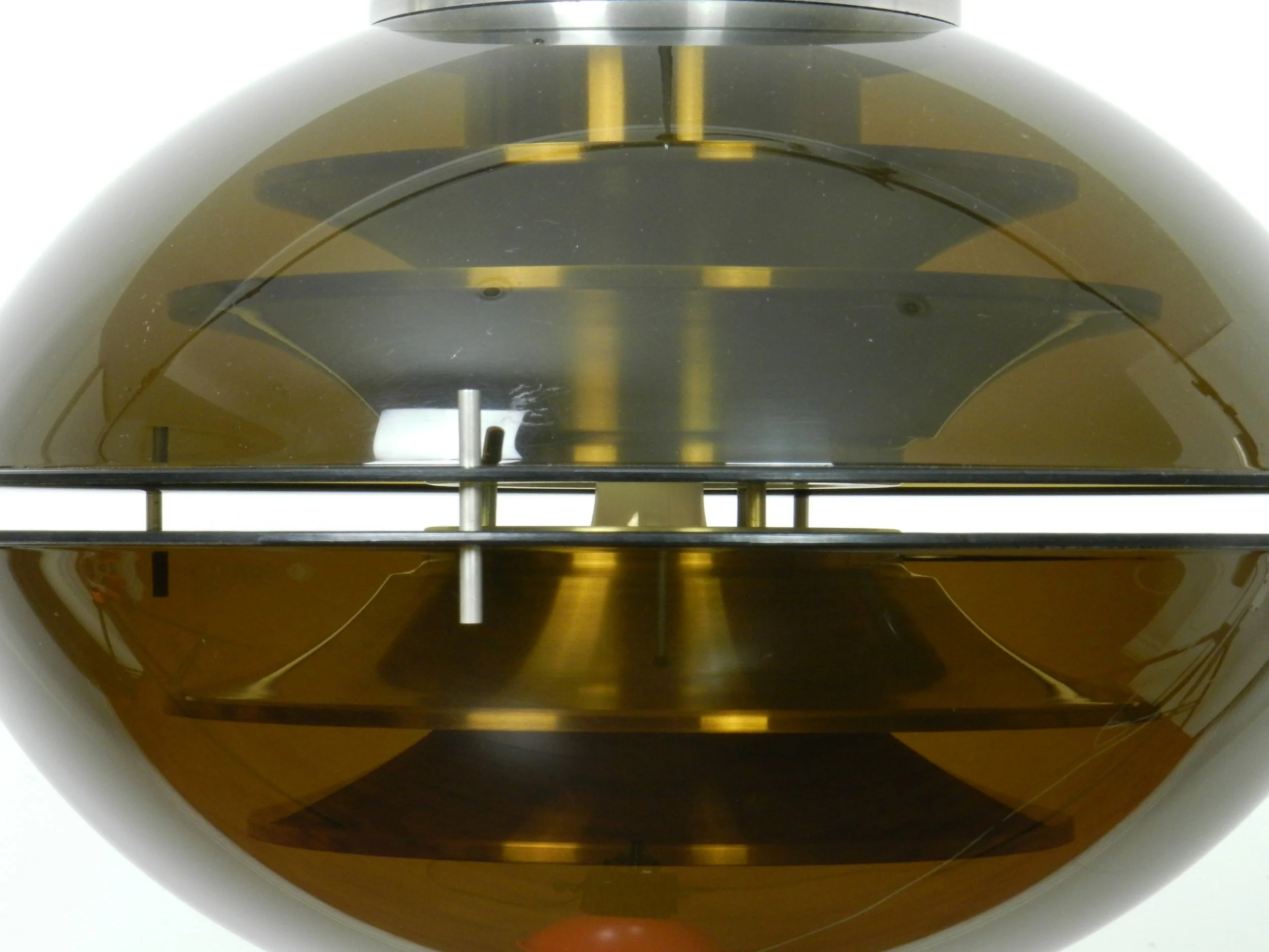 Space age pendant lamp with tinted acrylic outer shell and stacked aluminum plates on the interior by Herda.  Netherlands, 1970s.