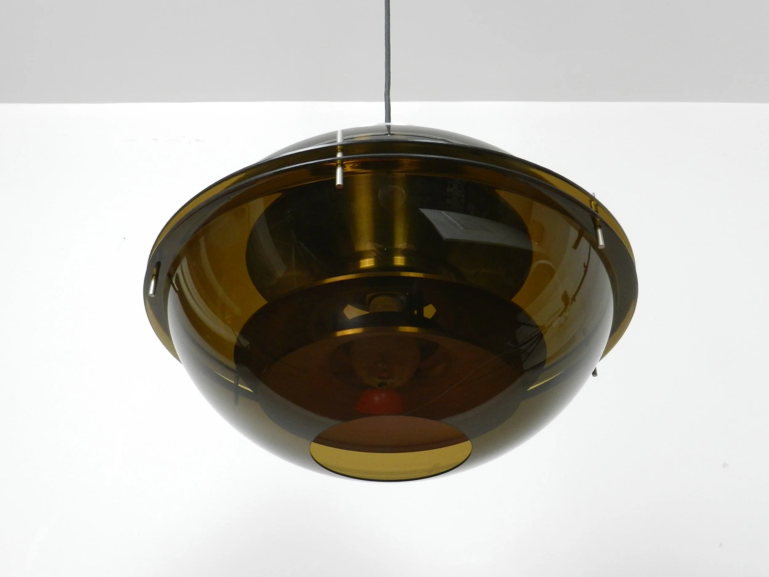 Space age pendant lamp with tinted acrylic outer shell and stacked aluminum plates on the interior by Herda.  Netherlands, 1970s.