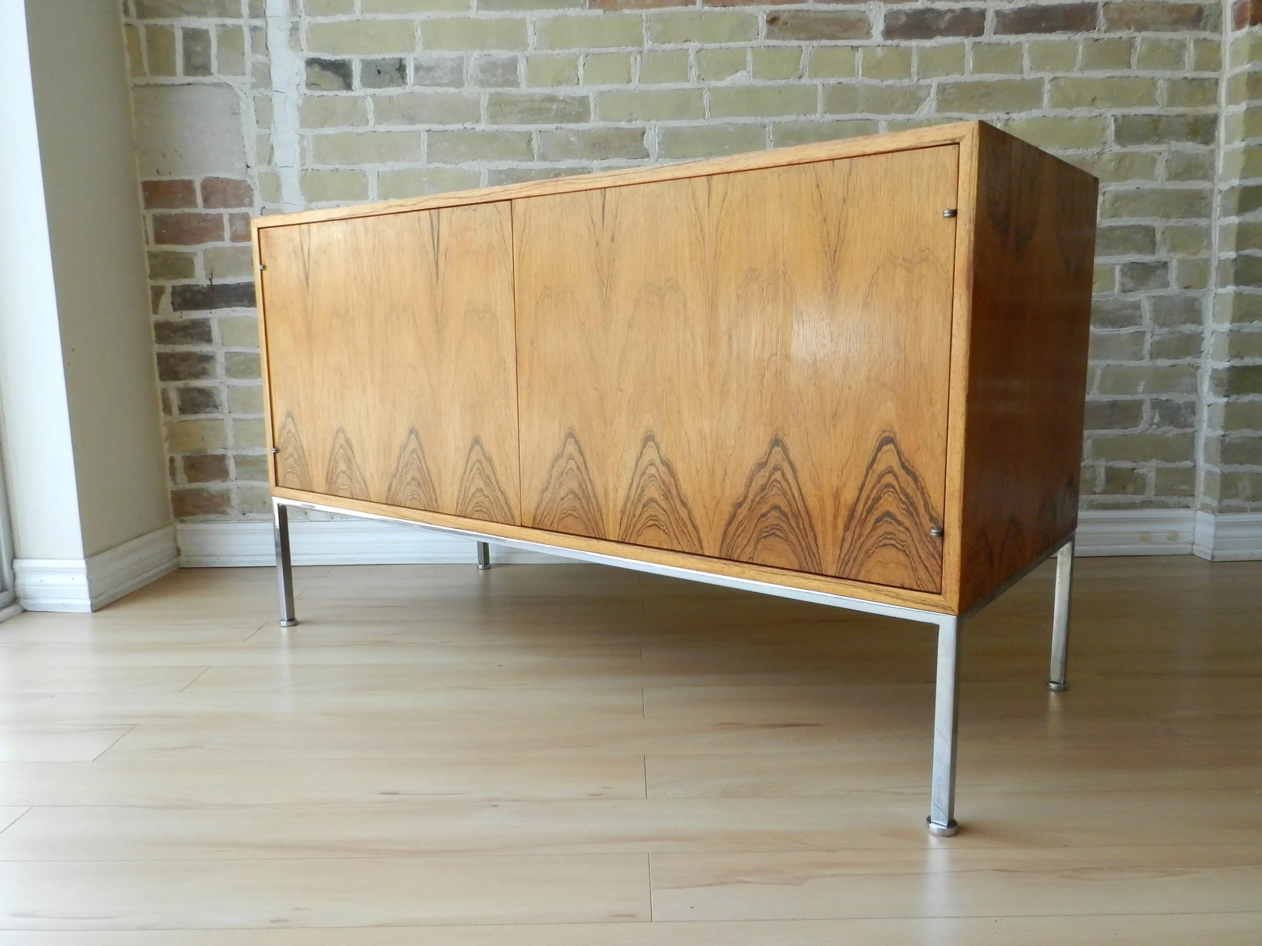 Mid century modern rosewood sideboard on chromed steel base designed by Leif Jacobsen.  Canada, 1960s,