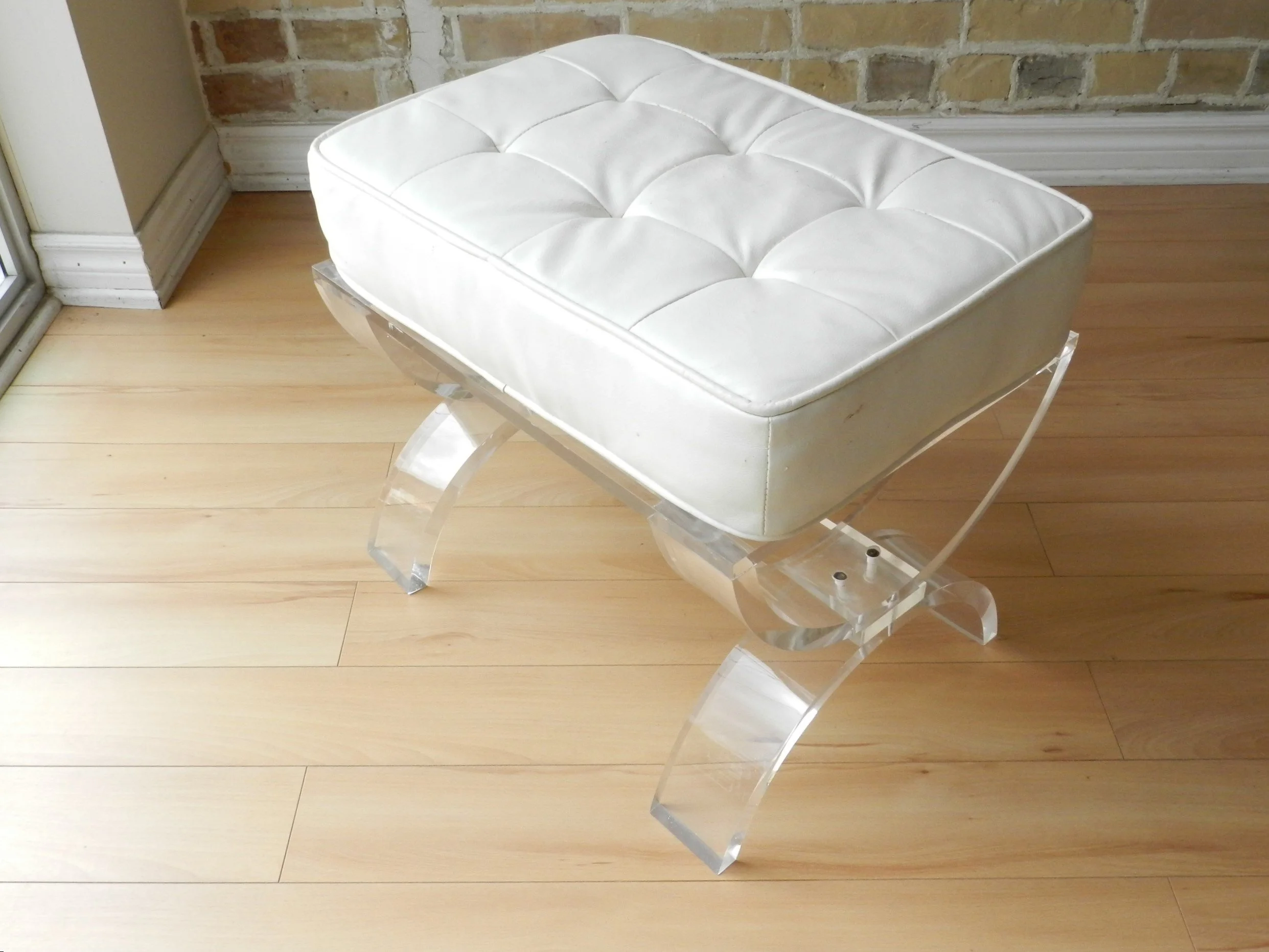 Vintage lucite bench with vinyl upholstered cushion.  circa 1980s.