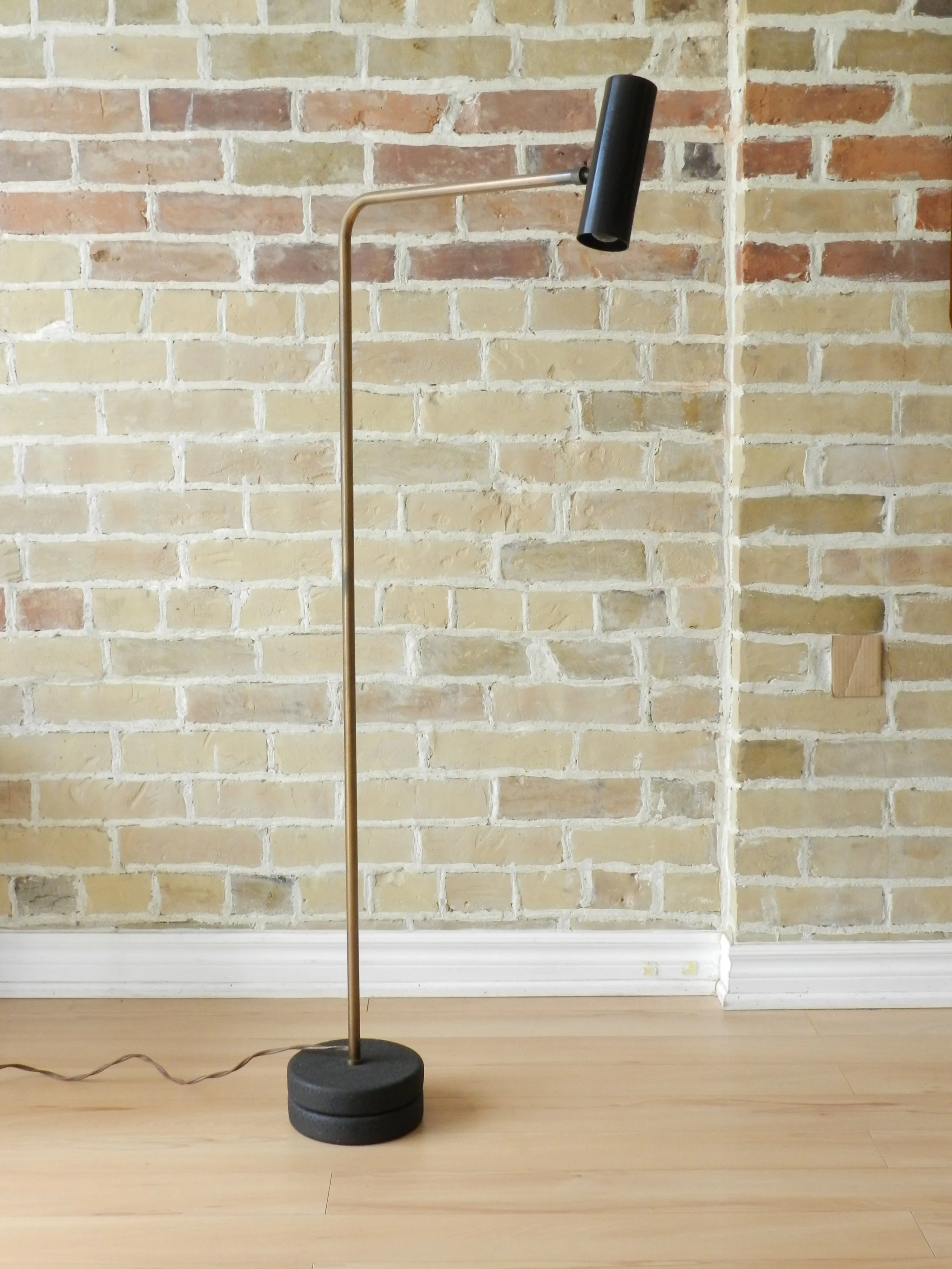 Modernist floor lamp in bronze plated arm, cast iron base and anodized aluminum shade. Designed by Robert Sonneman.  USA, 1960s.