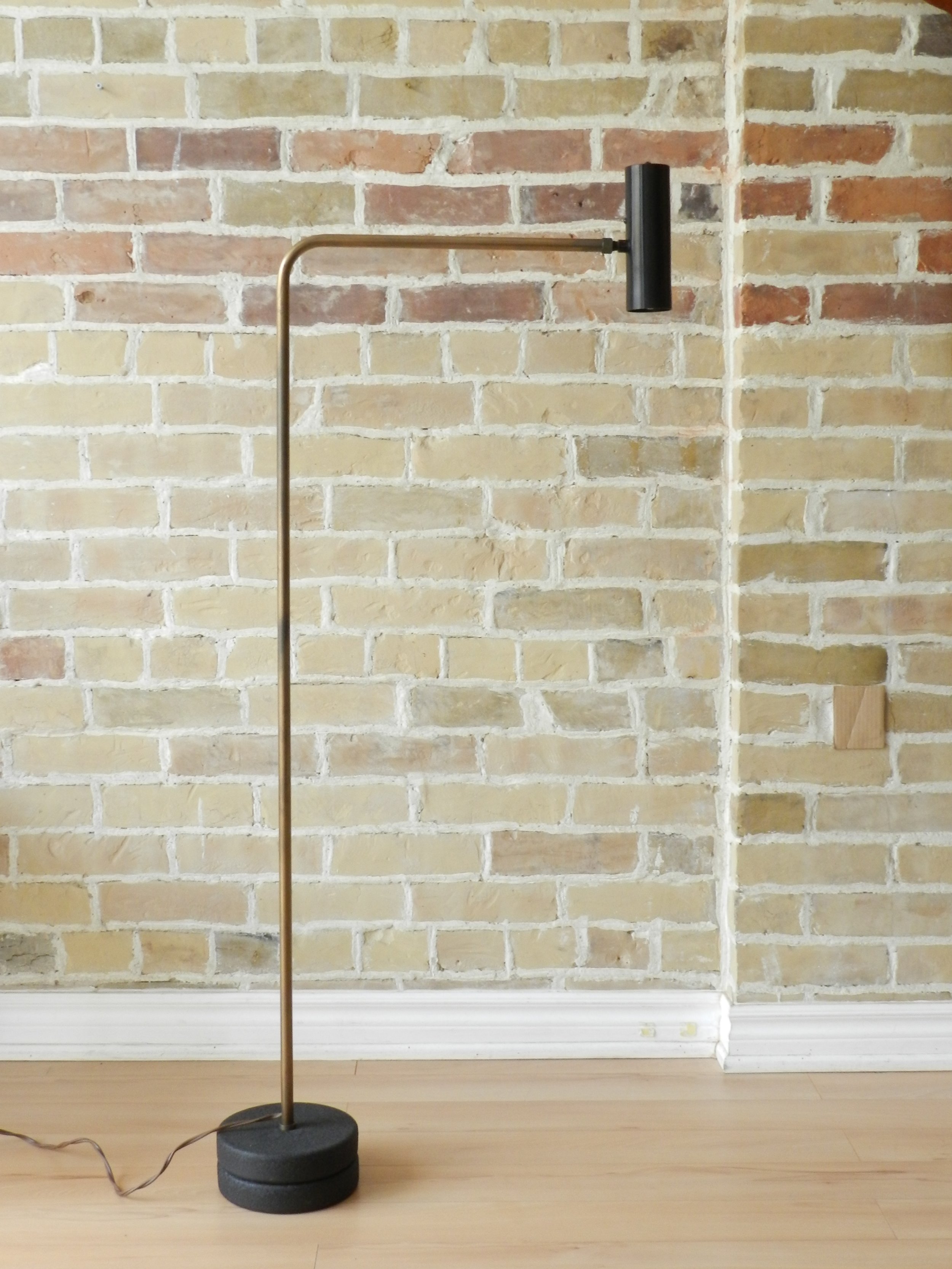 Modernist floor lamp in bronze plated arm, cast iron base and anodized aluminum shade. Designed by Robert Sonneman.  USA, 1960s.