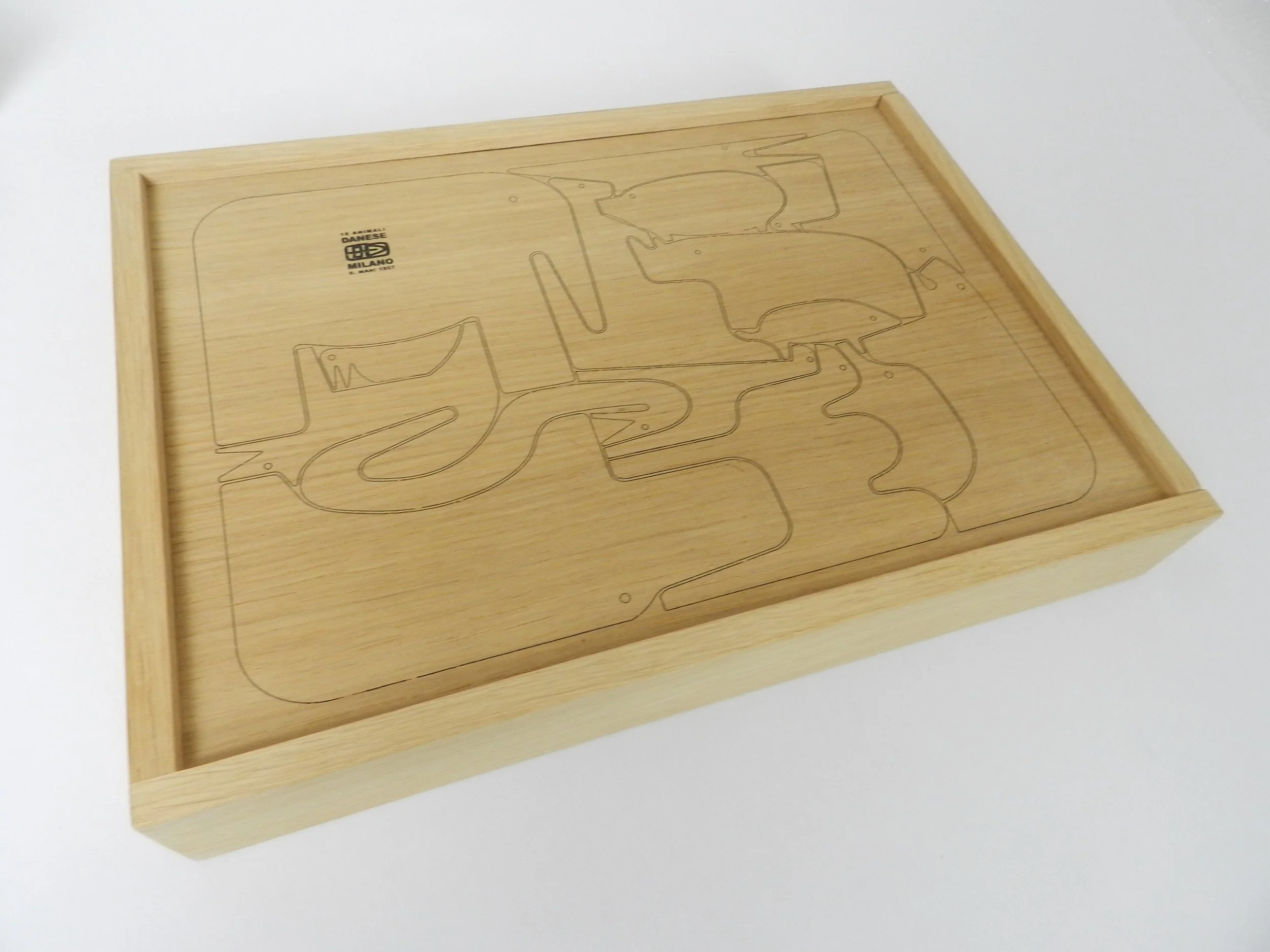 16 animal oak puzzle designed by Enzo Mari. designed in 1957, thos is a more recent production with original wood case and box.