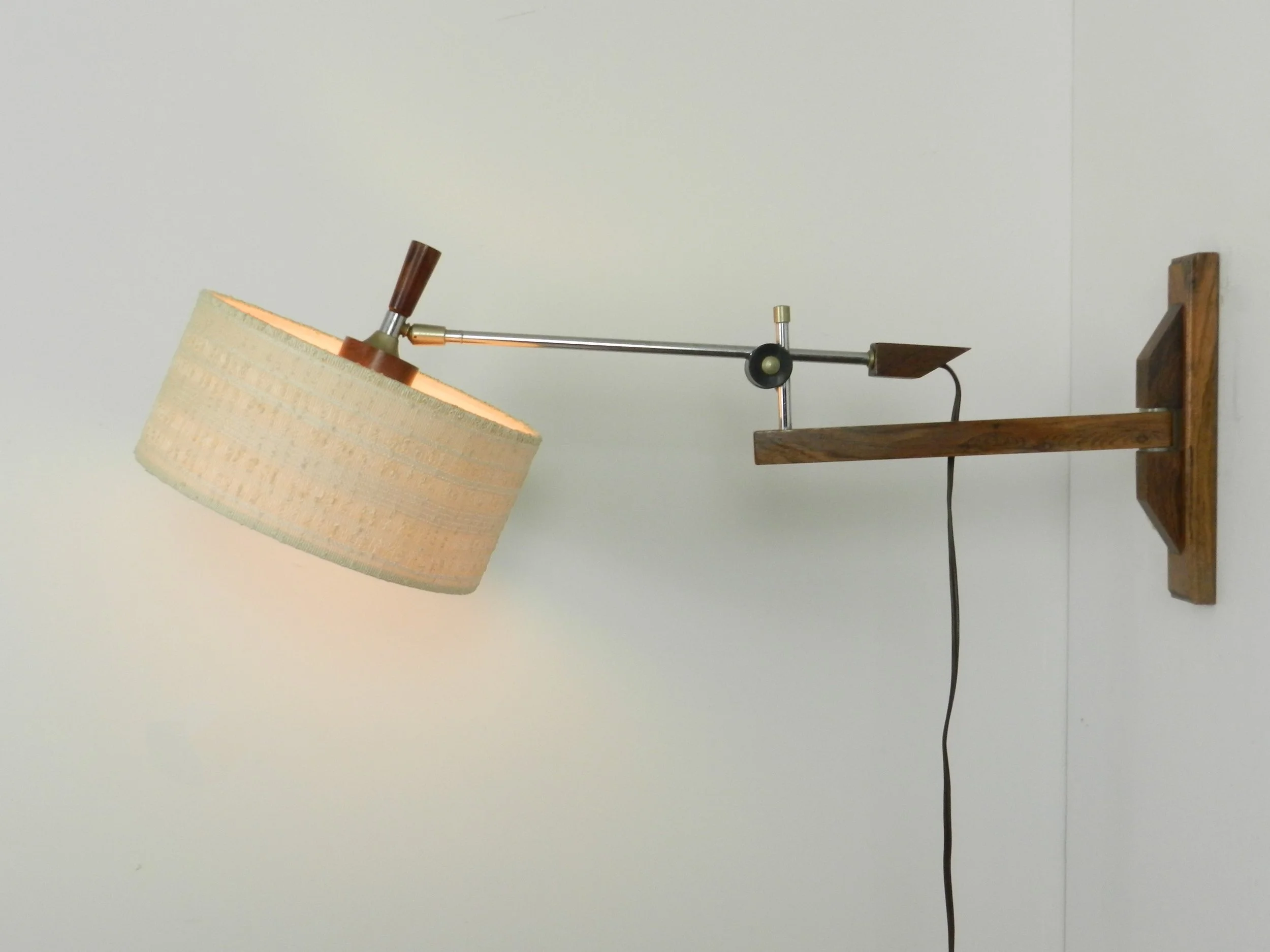 Scandinavian rosewood and chrome articulating wall lamp with original shade.  circa 1960s.