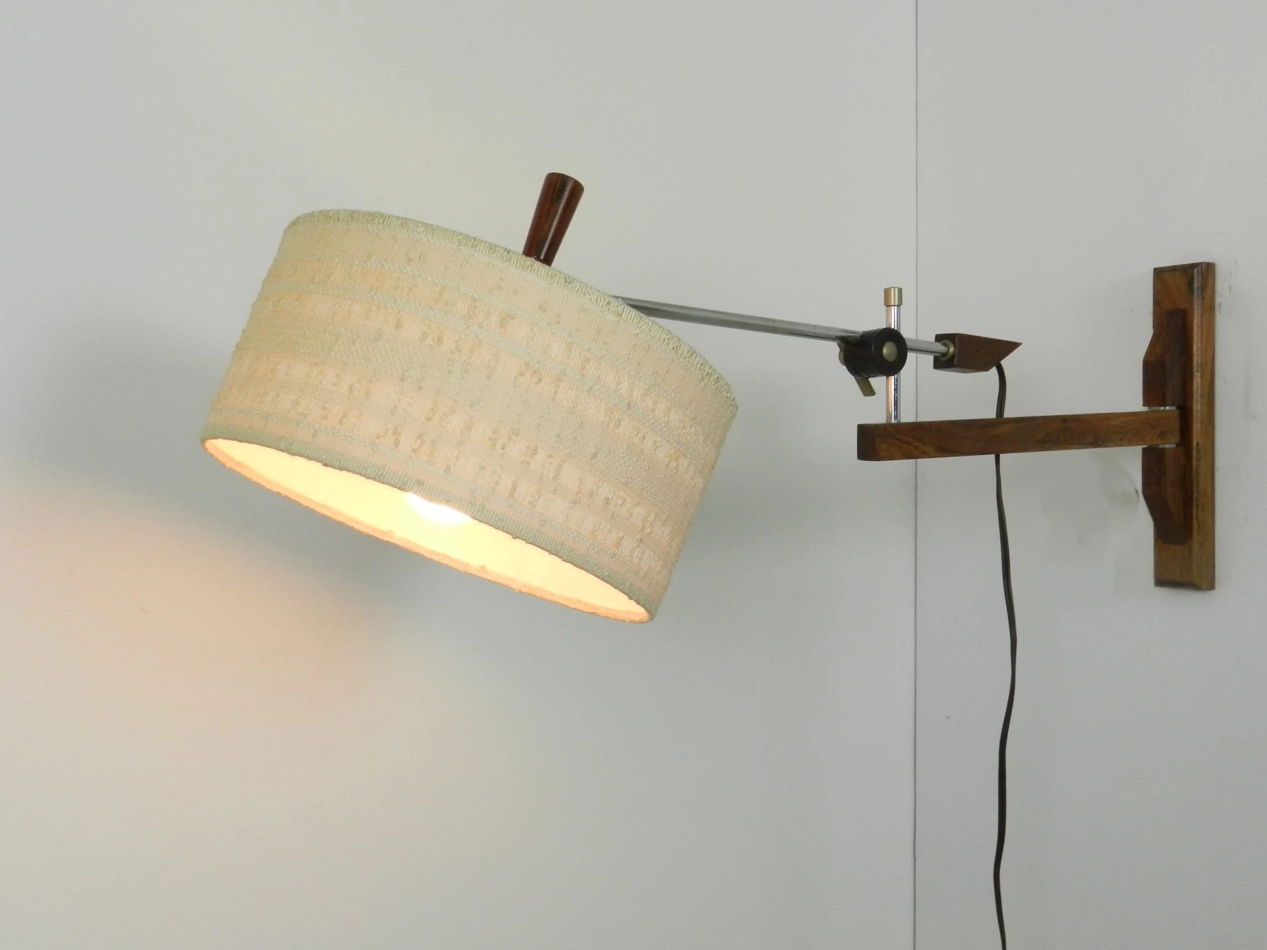 Scandinavian rosewood and chrome articulating wall lamp with original shade.  circa 1960s.