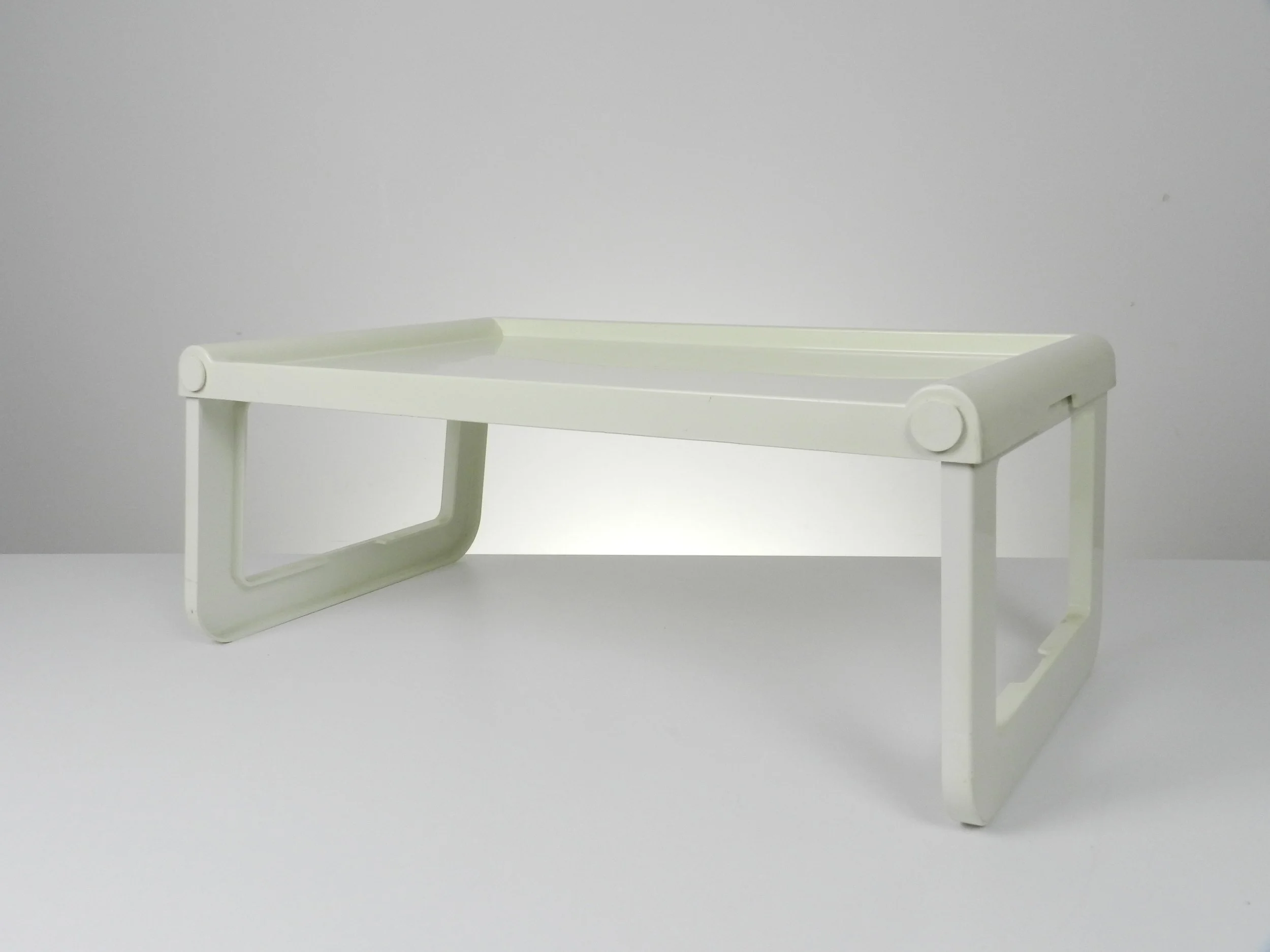 Vintage folding plastic bed tray designed by Luigi Massoni for Guzzini. 2 available.  Italy, 1970s.