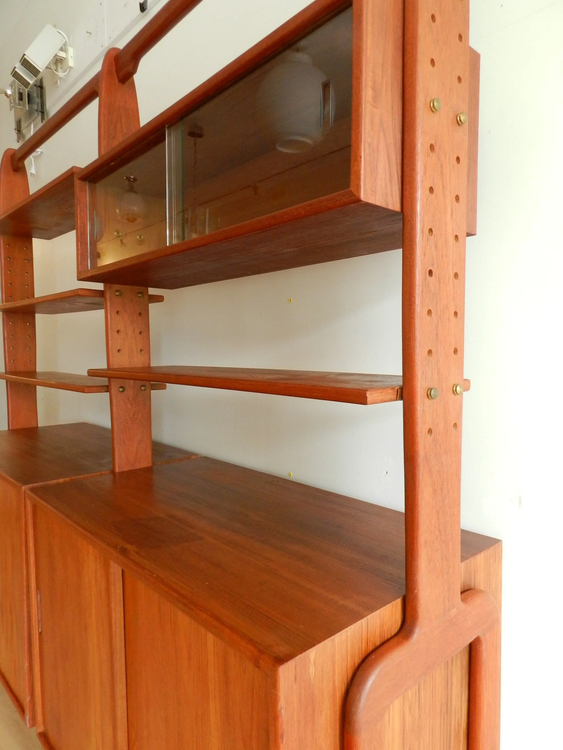 Modular teak wall unit with adjustable shelves.  Scandinavia, 1960s.