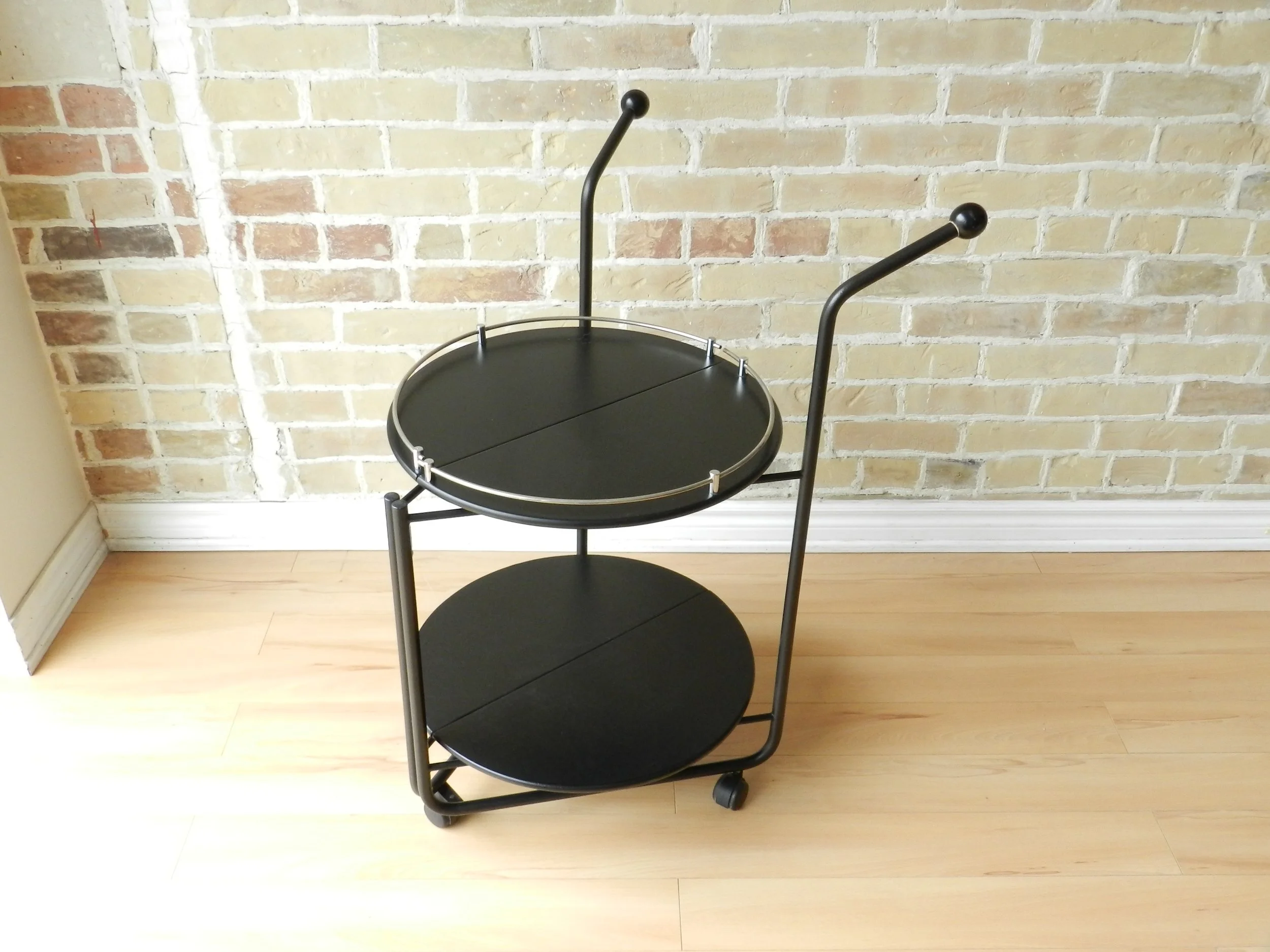 Post modern folding bar cart in painted wood and enameled metal.  Italy, 1980s.
