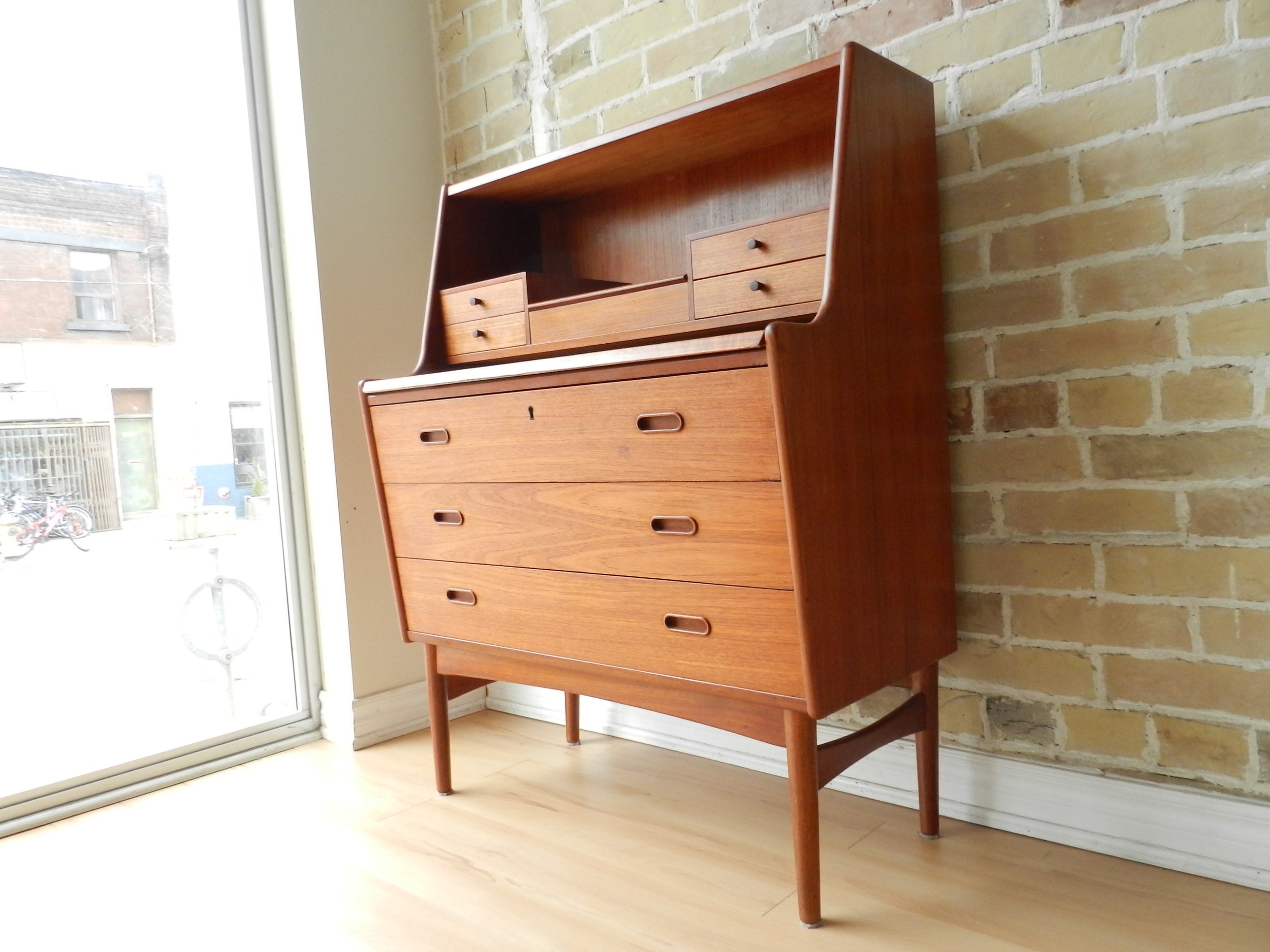 Teak secretary desk with pop up mirror retractable desk top. Designed by Arne Wahl Iversen for Vinde Mobelfabrik.  Denmark, 1960s.