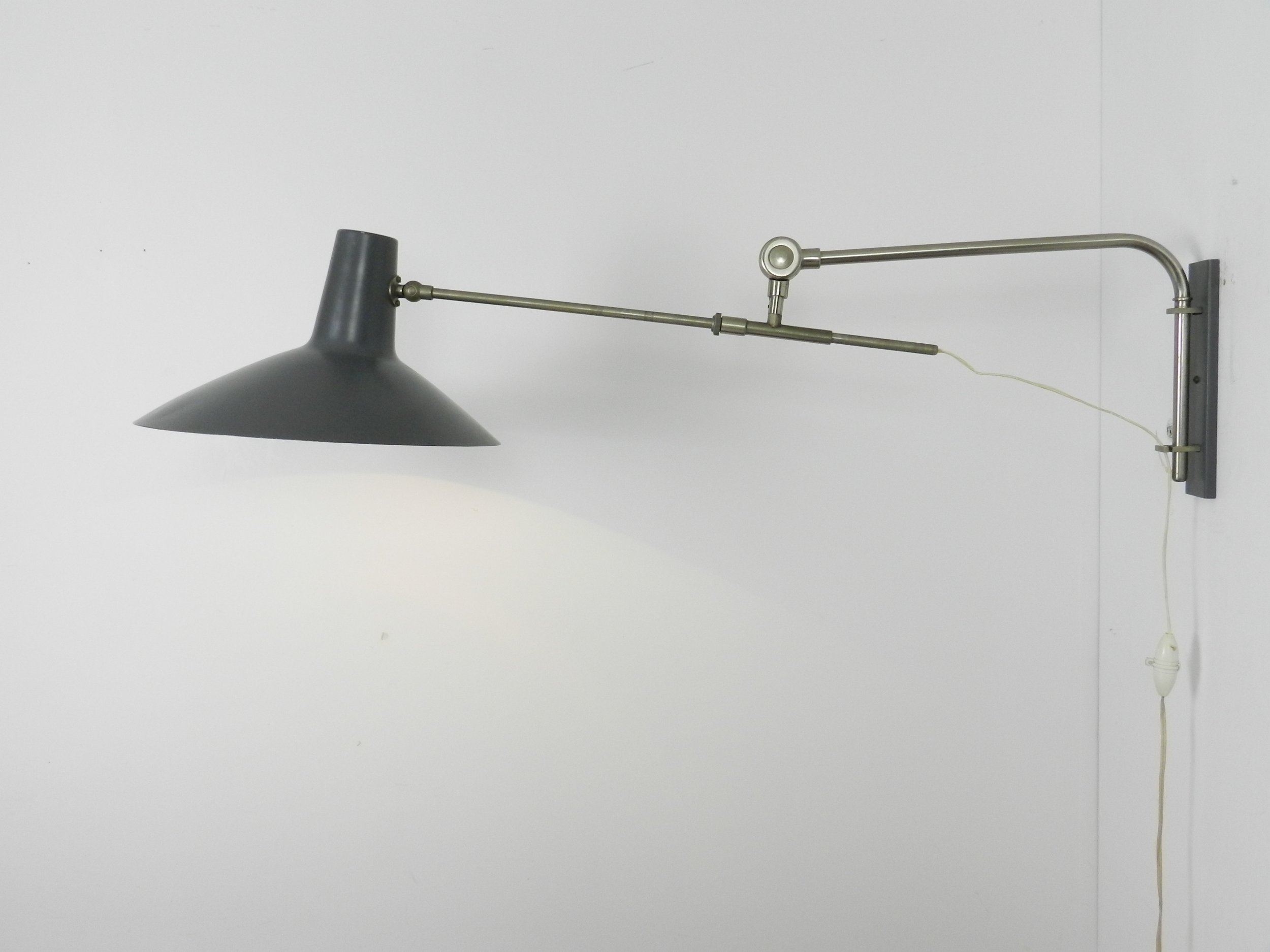 Mid century modern articulating wall lamp by Artimeta.  Netherlands, 1950s.