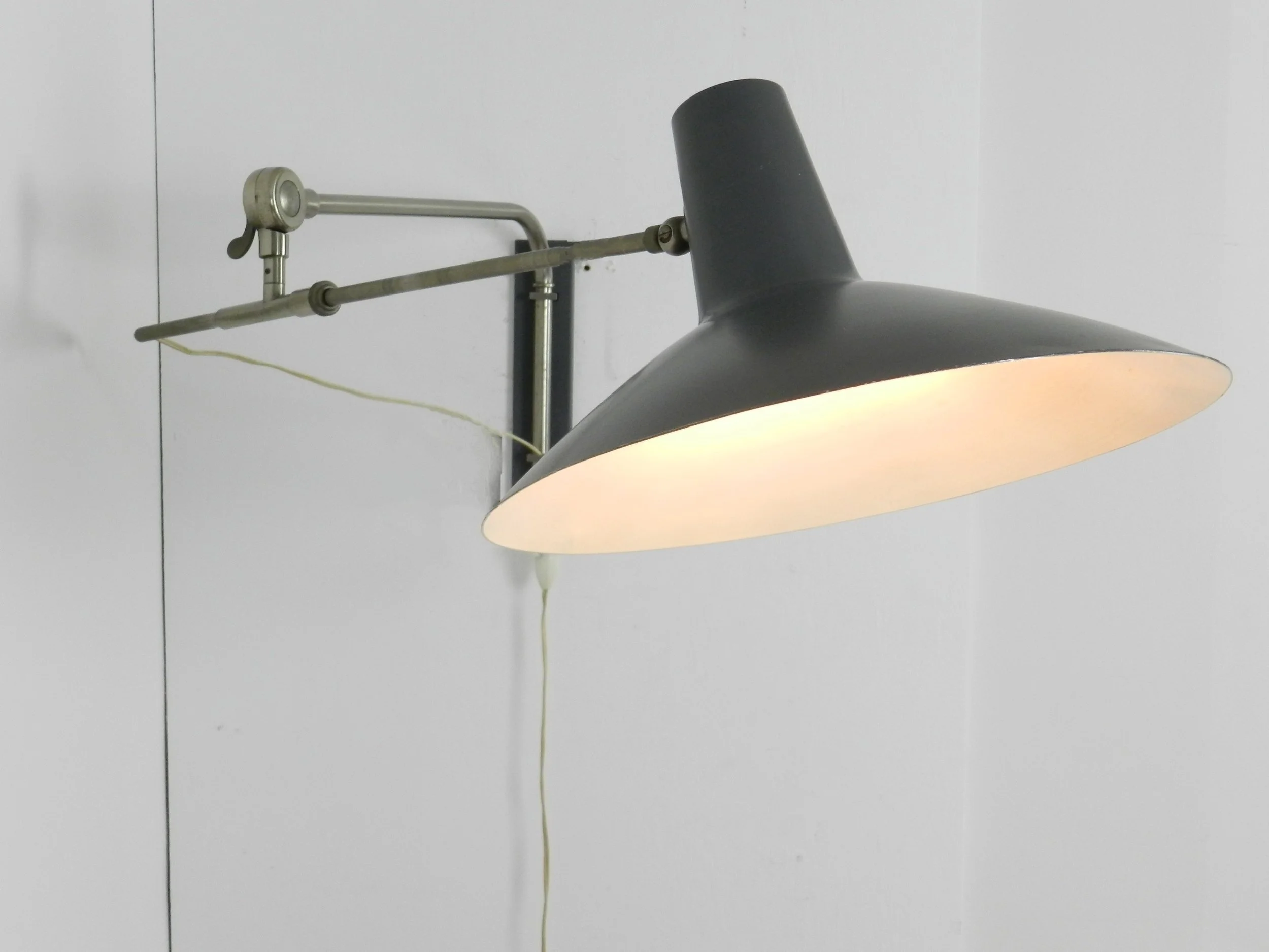 Mid century modern articulating wall lamp by Artimeta.  Netherlands, 1950s.