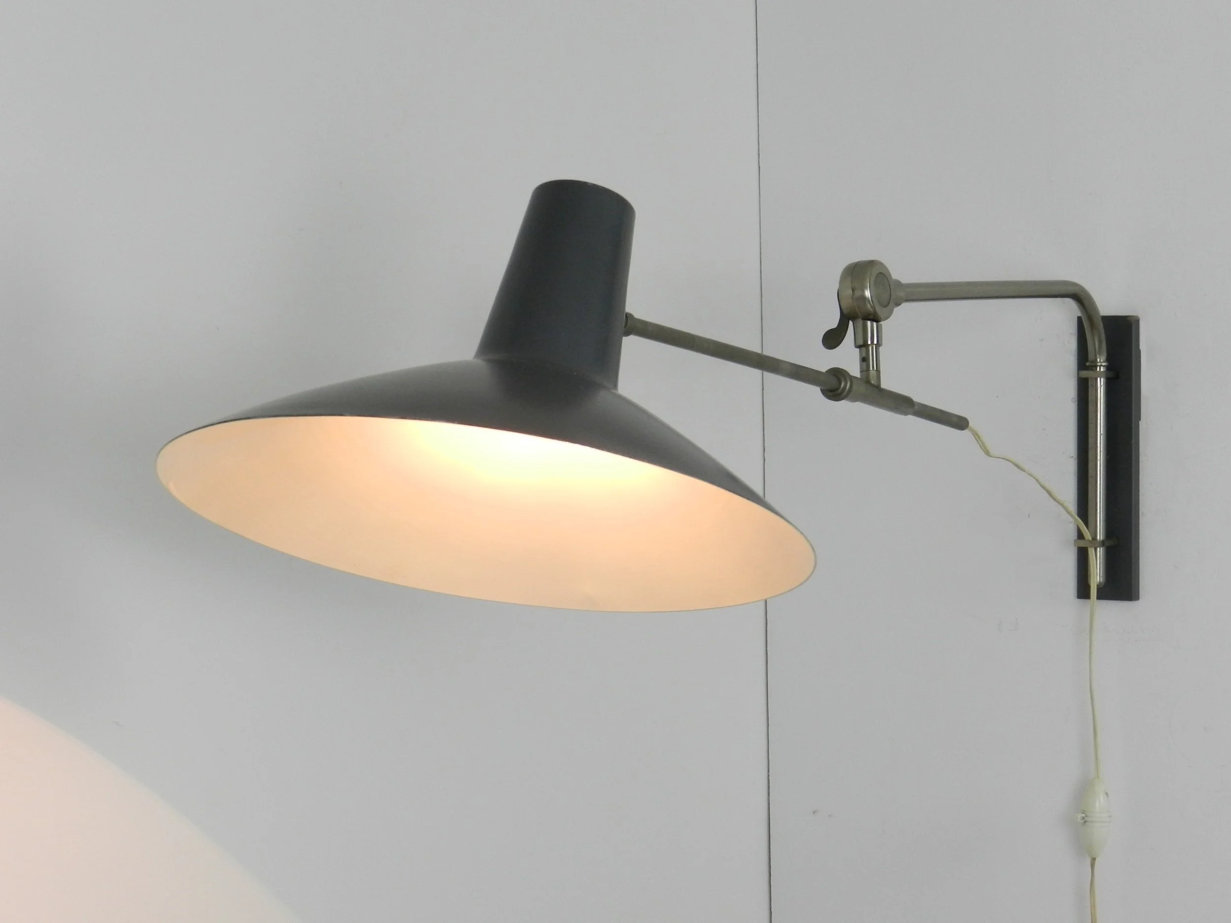 Mid century modern articulating wall lamp by Artimeta.  Netherlands, 1950s.