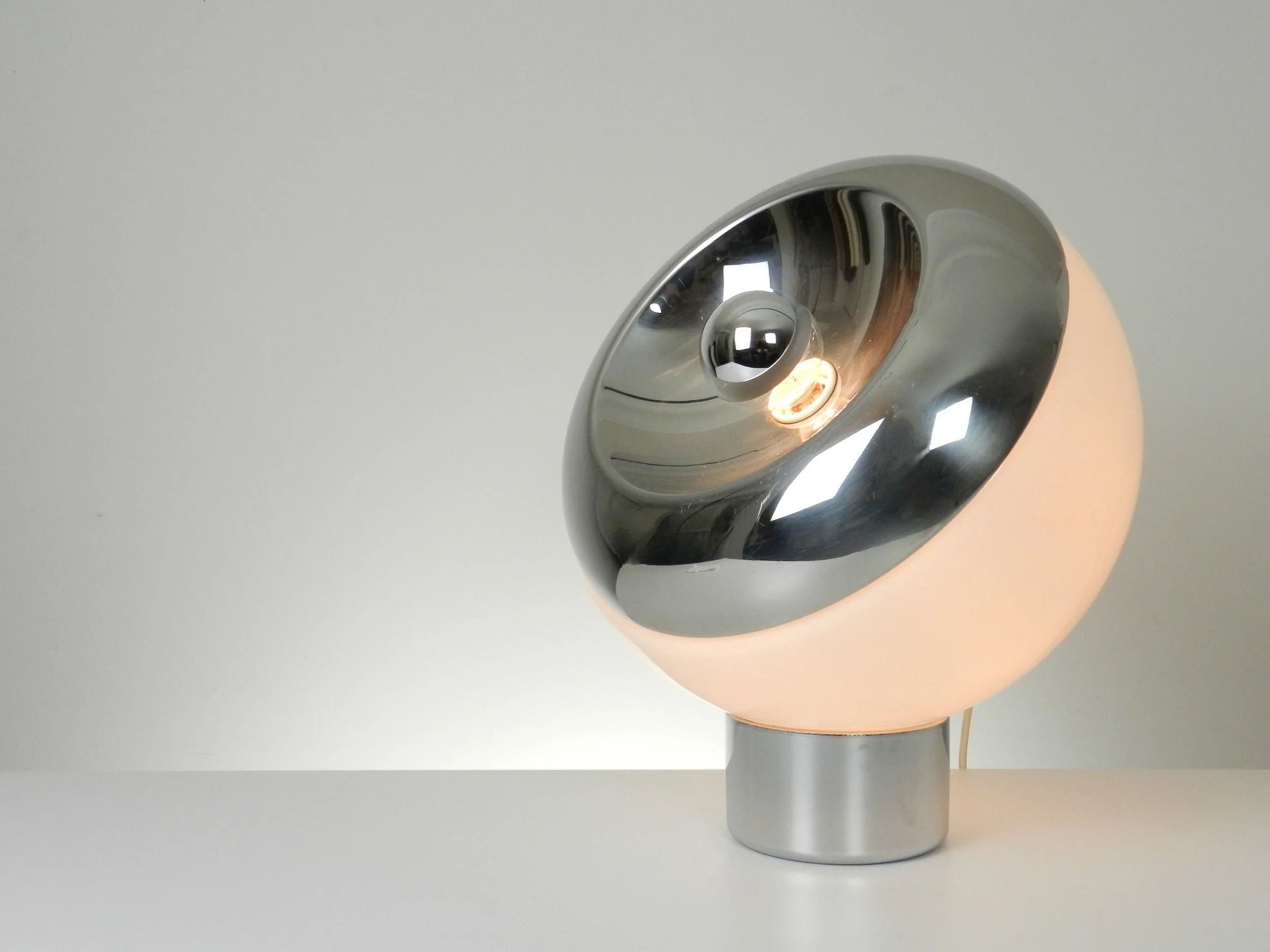 Large space age lamp in opaline glass and chrome by Reggiani. Can be used as a table or floor lamp.  Italy, 1970s.