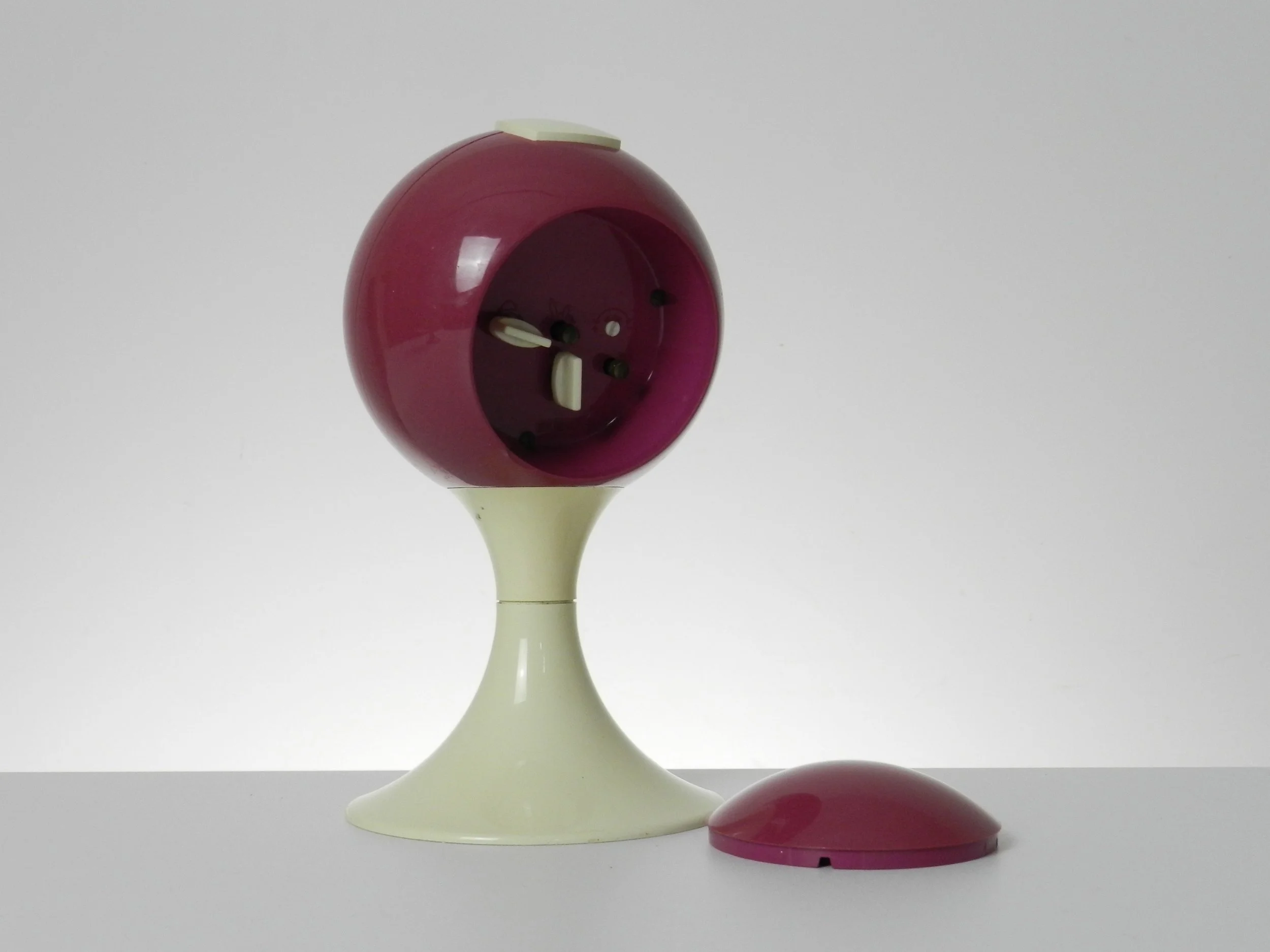 Space age pedestal clock in pink and cream colored plastic by Blessing.  West Germany, 1970s.