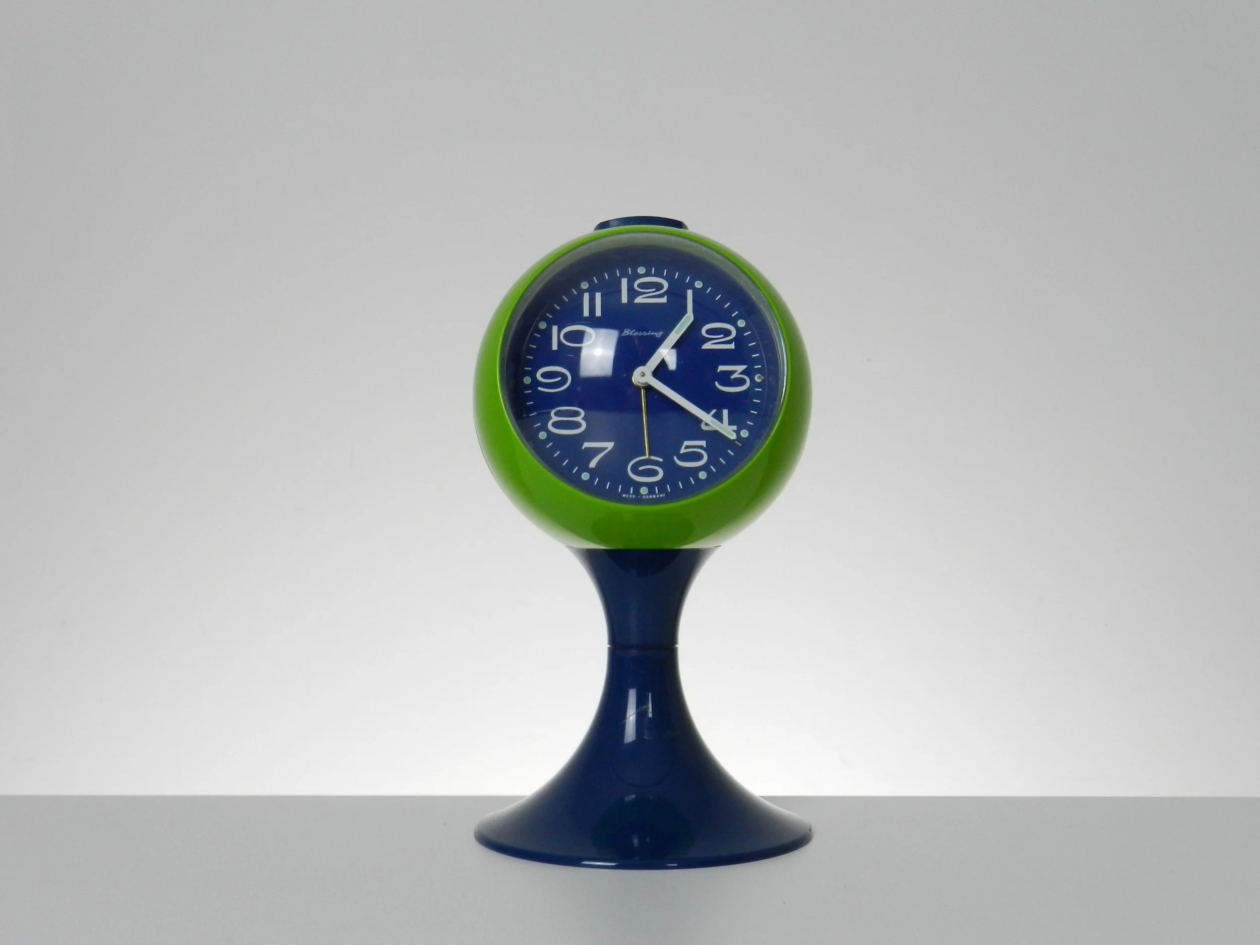 Space age pedestal clock in blue and green colored plastic by Blessing.  West Germany, 1970s.