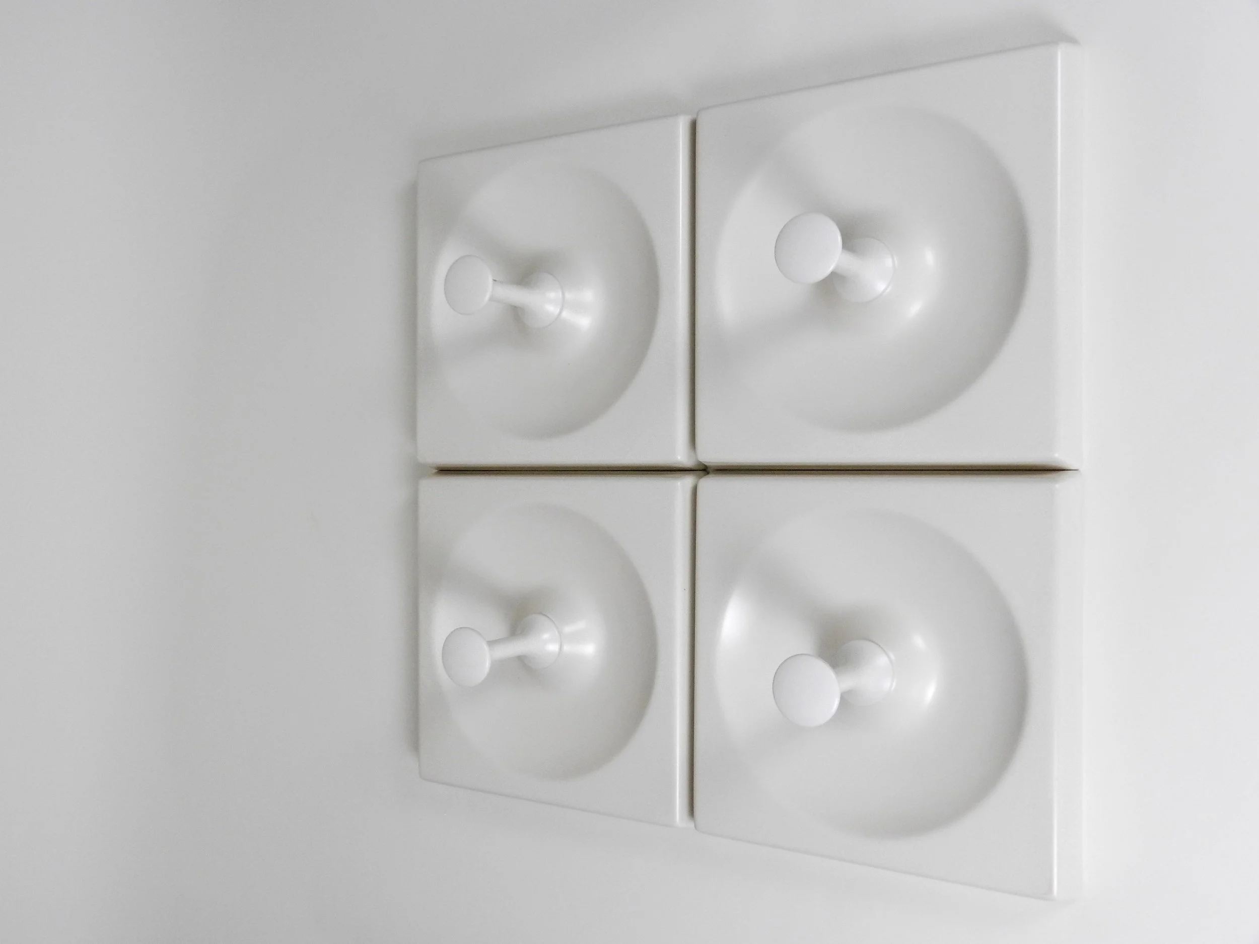 Set of 4 large space age coat hooks in plastic and painted wood by Schonbuch. Each element can mounted separetly.  Germany, 1970s.