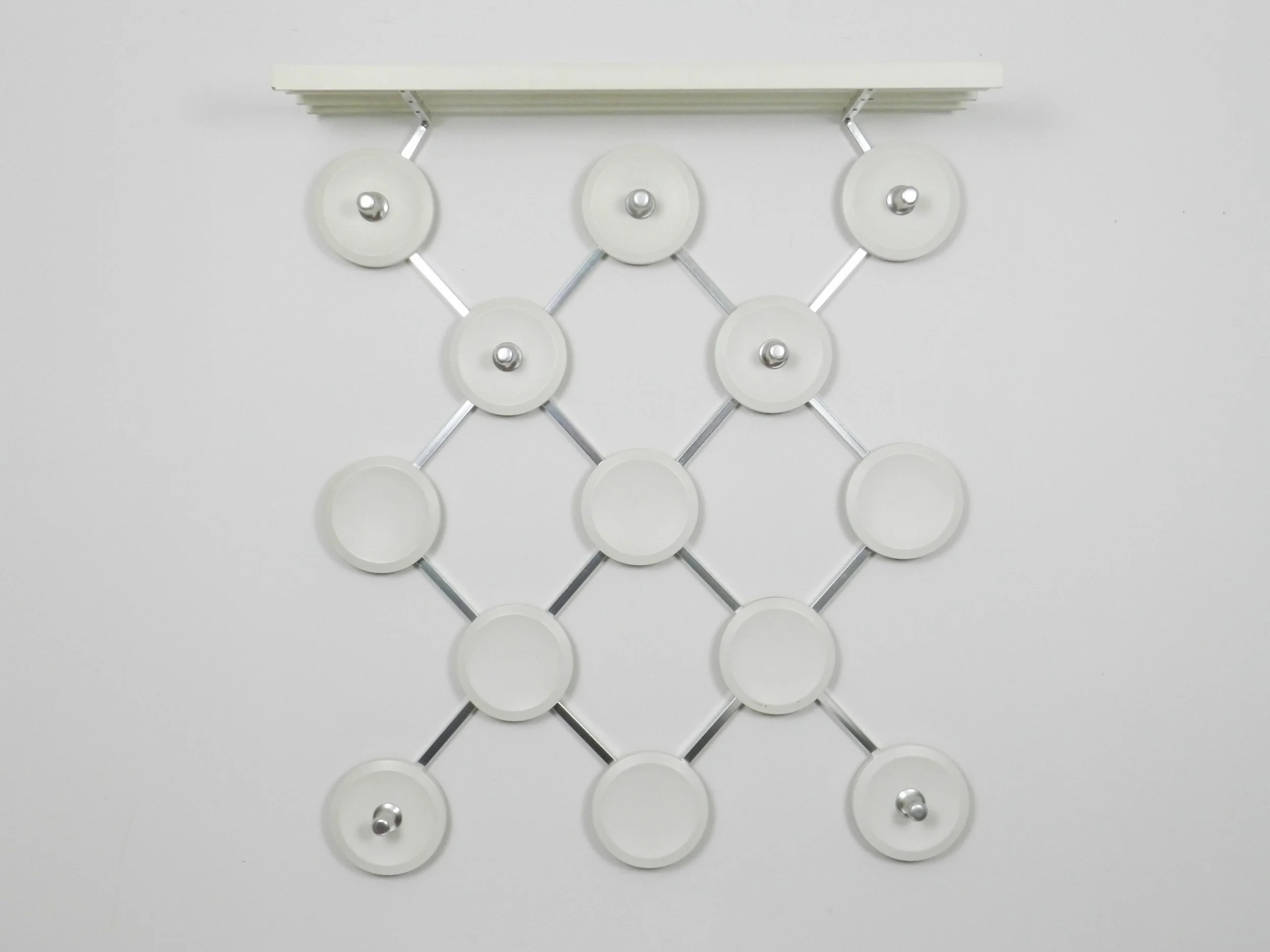 Space age wall mounted coat rack in aluminum and painted wood.  Germany, 1960s.