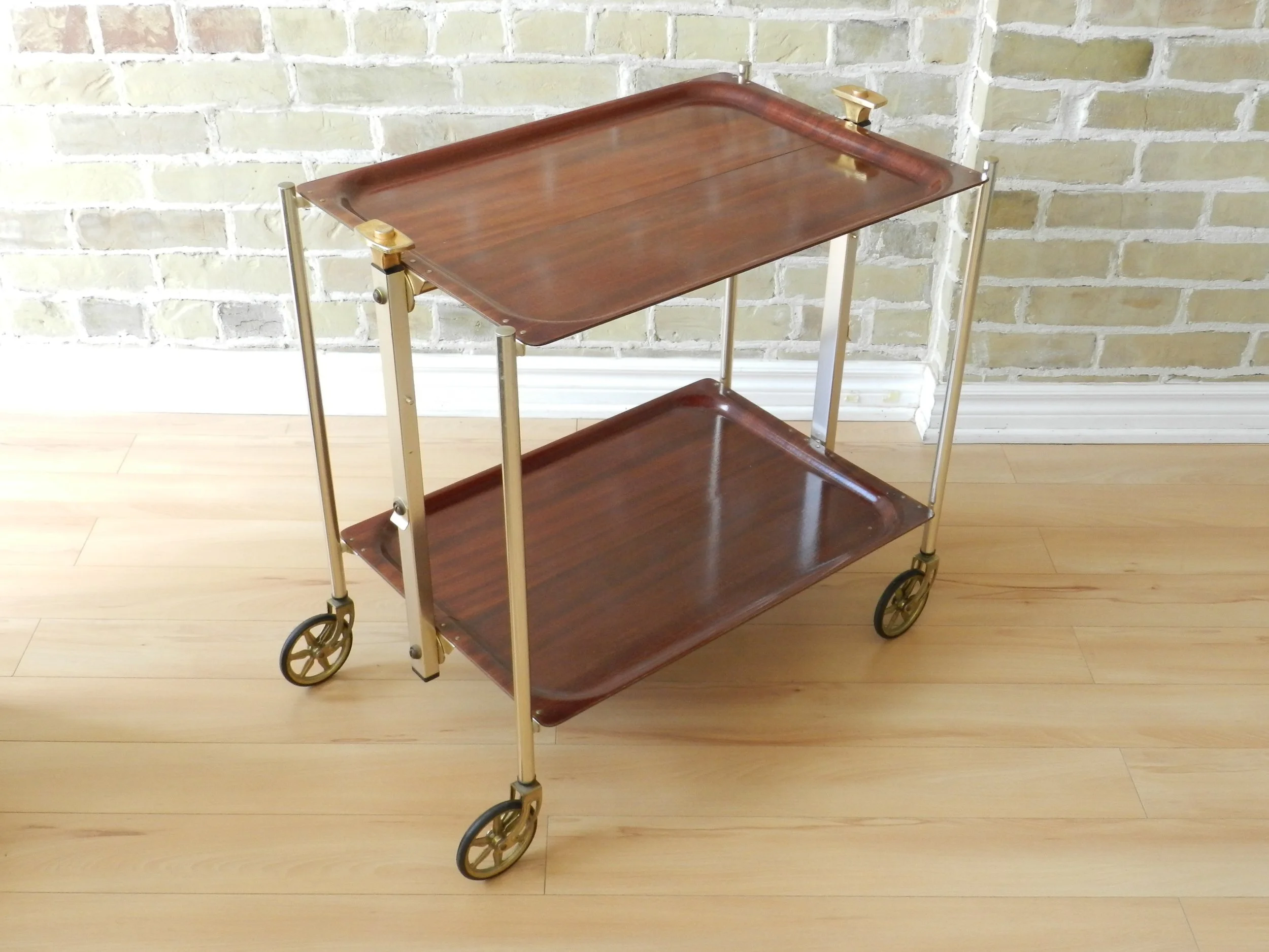 Mid Century modern folding bar cart by Textable de Levallois Perret. Laminated melamine tops with brass metal frame.  France, 1950s.