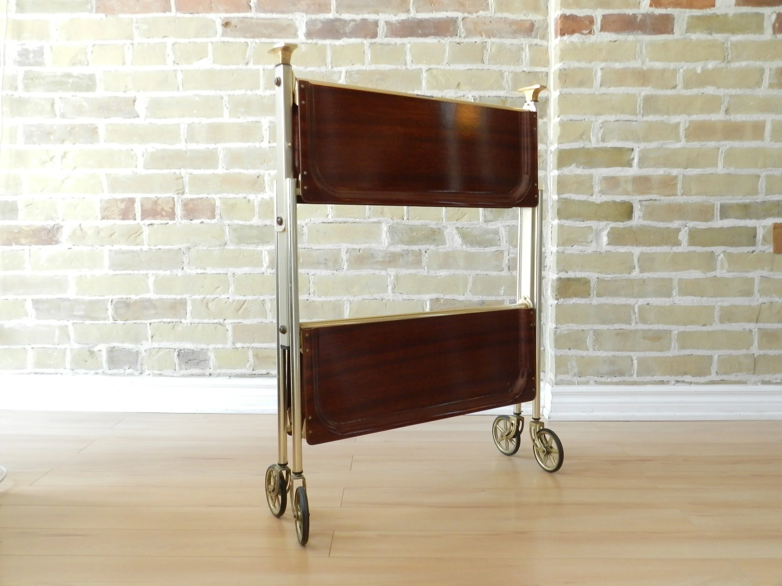Mid Century modern folding bar cart by Textable de Levallois Perret. Laminated melamine tops with brass metal frame.  France, 1950s.