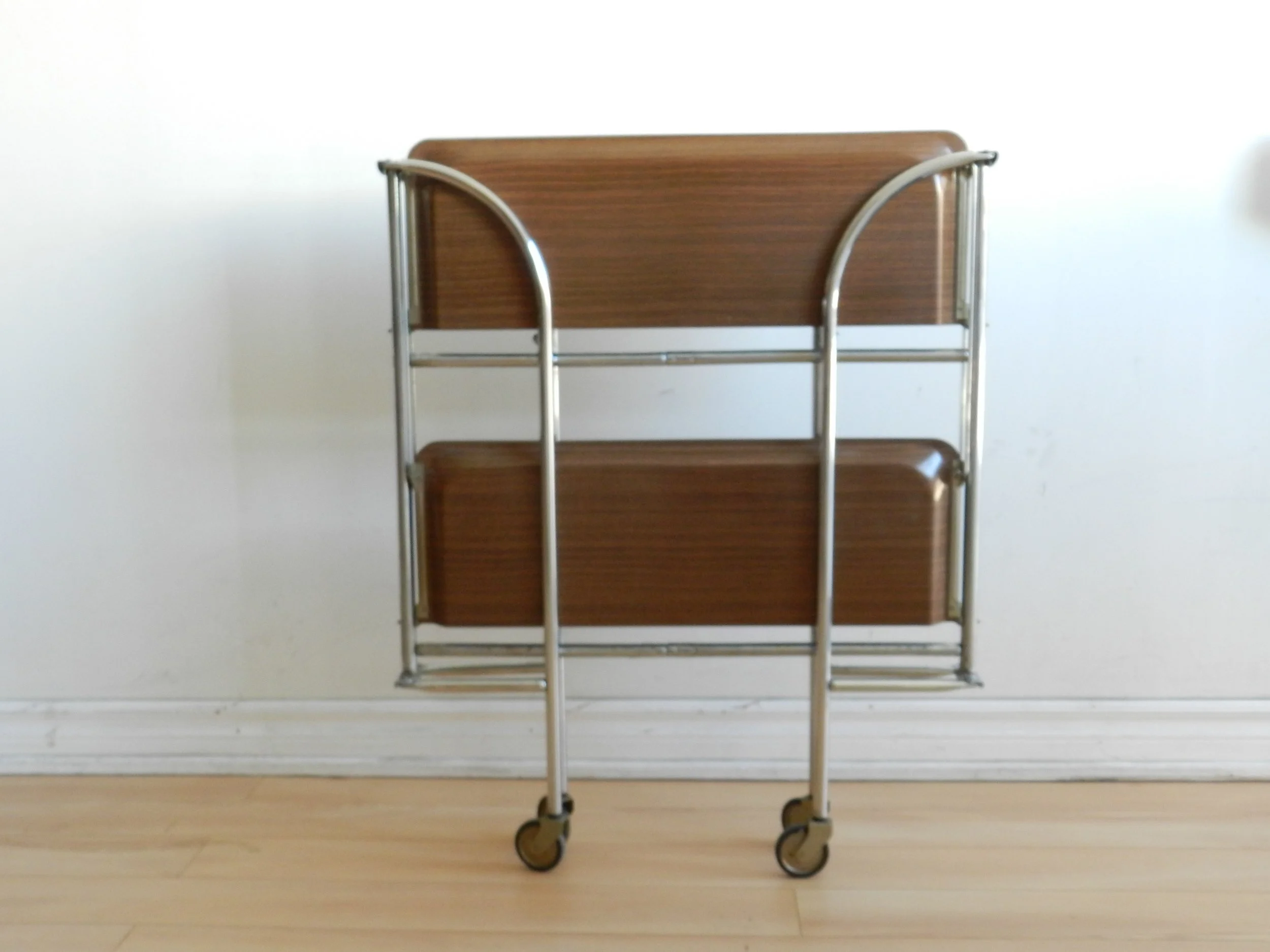 Vintage folding bar cart in chrome with fromica shelves.  Germany, 1960s.