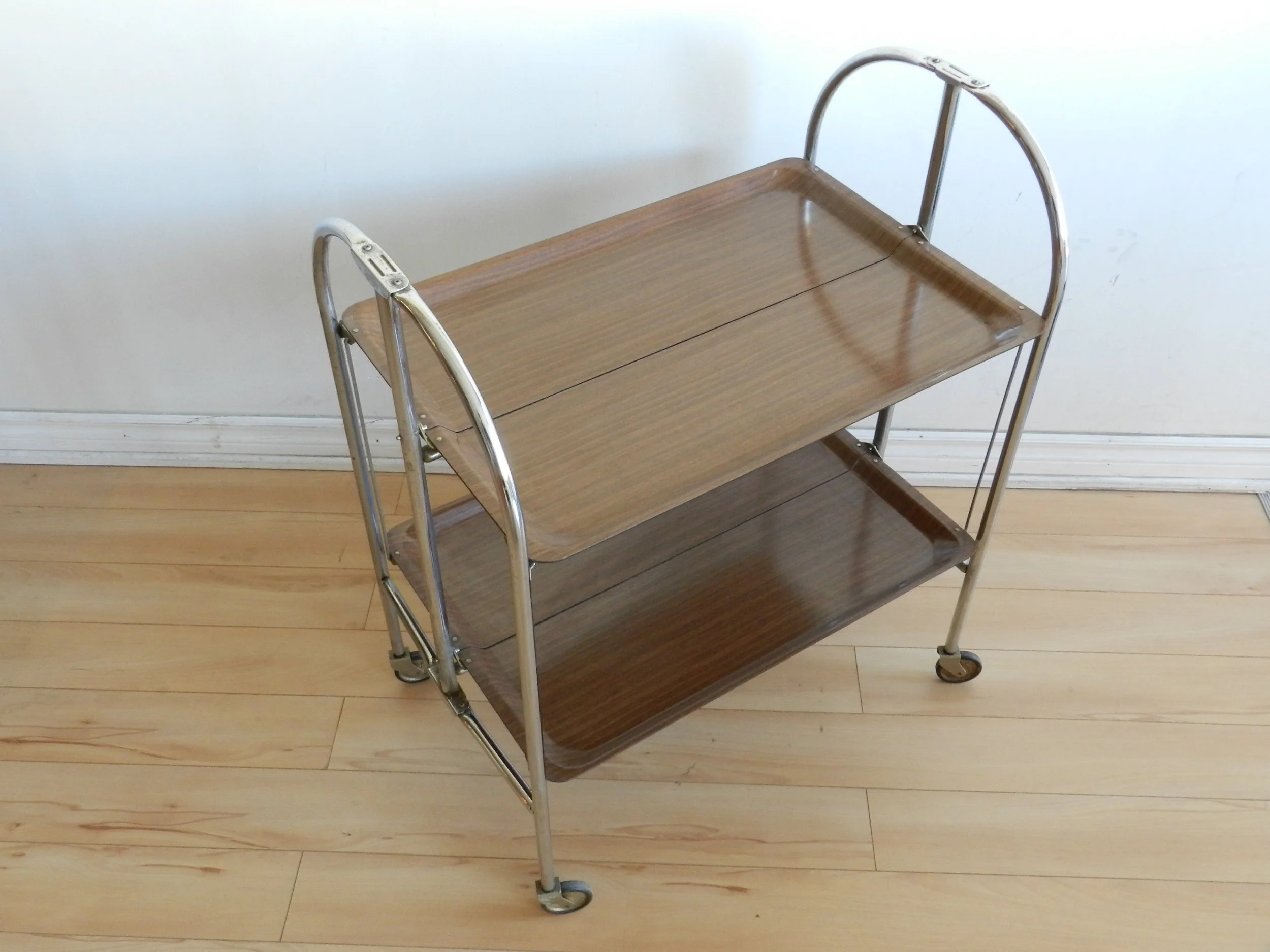 Vintage folding bar cart in chrome with fromica shelves.  Germany, 1960s.