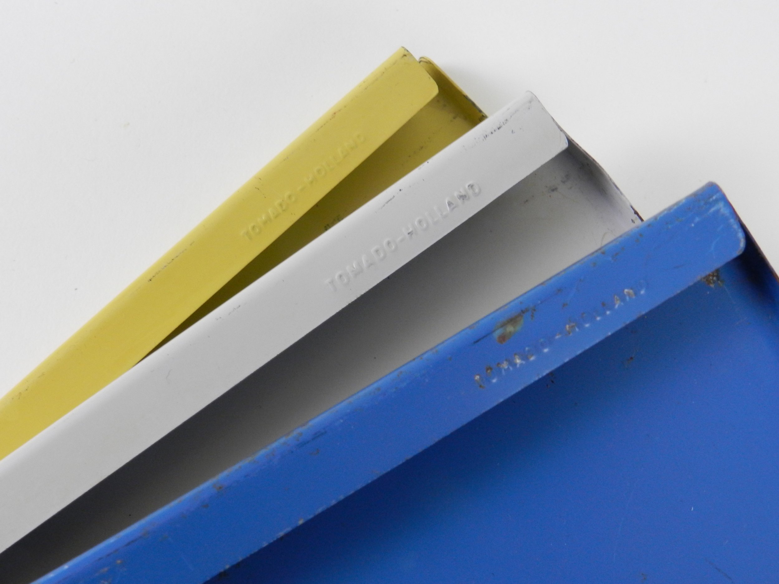 Mid century metal wall mount shelving unit with lamp by Tomado.  Netherlands, 1960s.