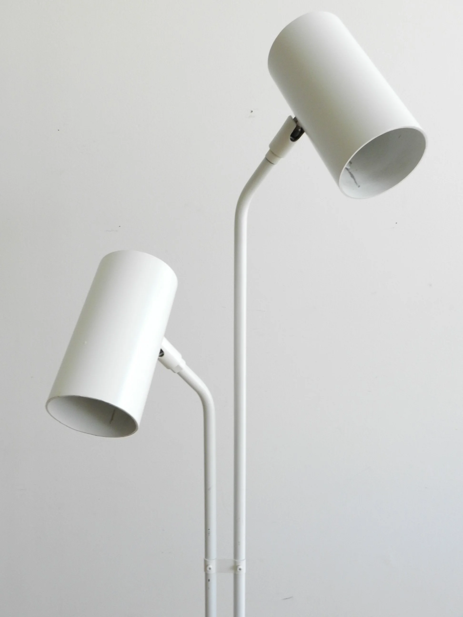 Modernist floor lamp in white enameled metal.  circa 1980s.