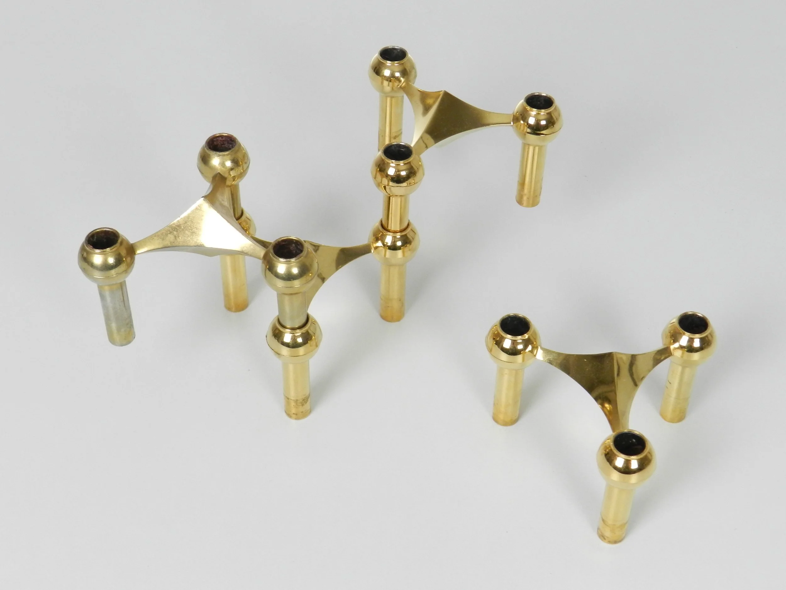 Set of 4 brass modular Nagel candle holders designed by Fritz Nagel and Ceasar Stoffi.  Germany, 1970s.