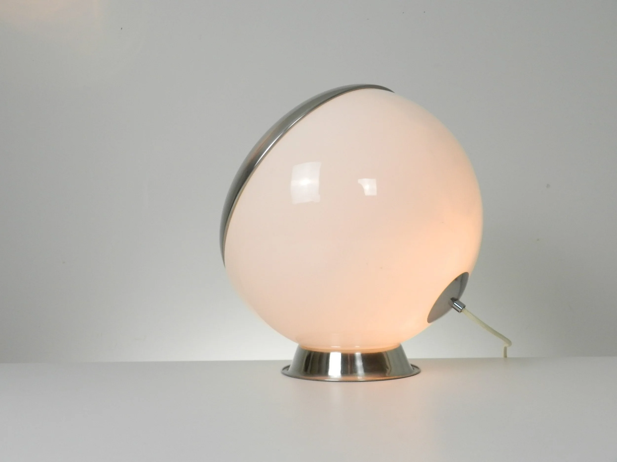 Large space age lamp in opaline glass and chrome by Reggiani. Can be used as a table or floor lamp.  Italy, 1970s.