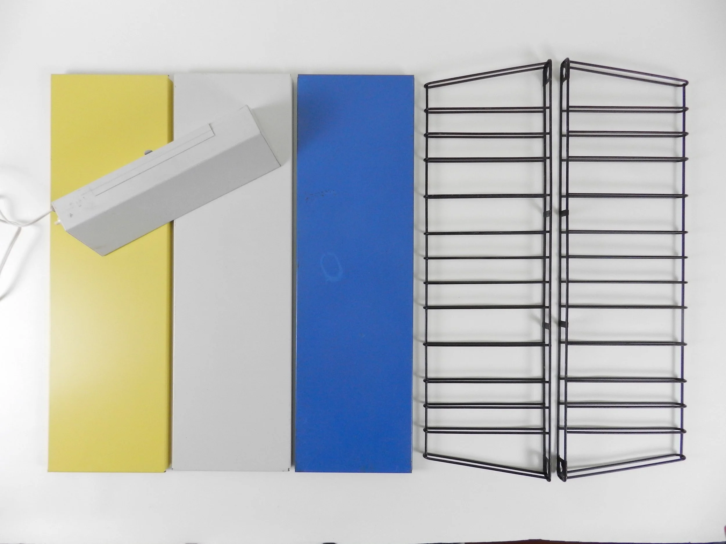 Mid century metal wall mount shelving unit with lamp by Tomado.  Netherlands, 1960s.