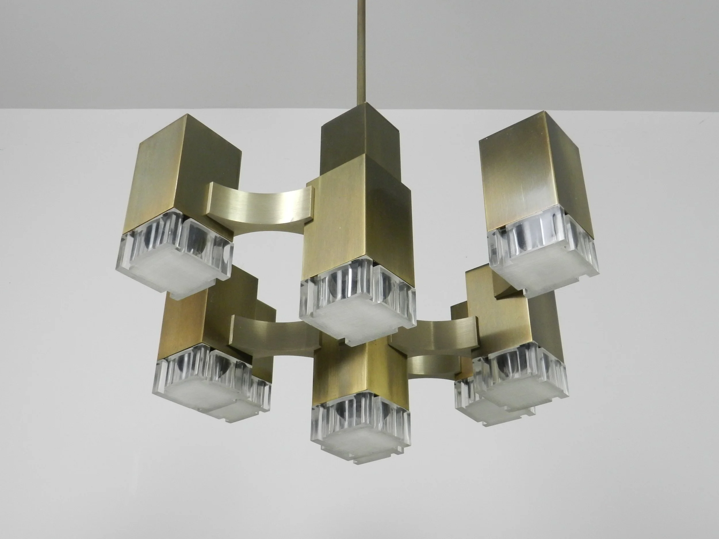 Modernist nine light “Cubic” chandelier designed by Gaetano Sciolari. In bronze plated metal with acrylic diffusers.  Italy, 1960s.