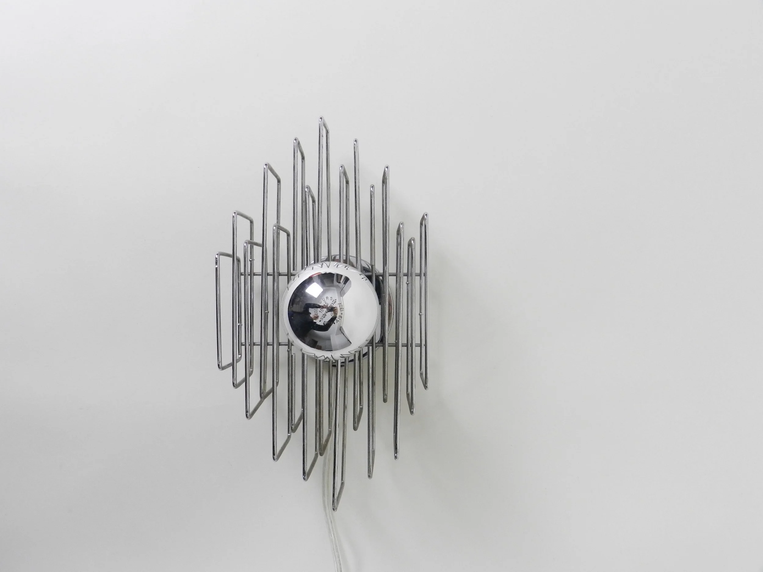 Modernist wall lamp in chrome wire.  circa 1970s.