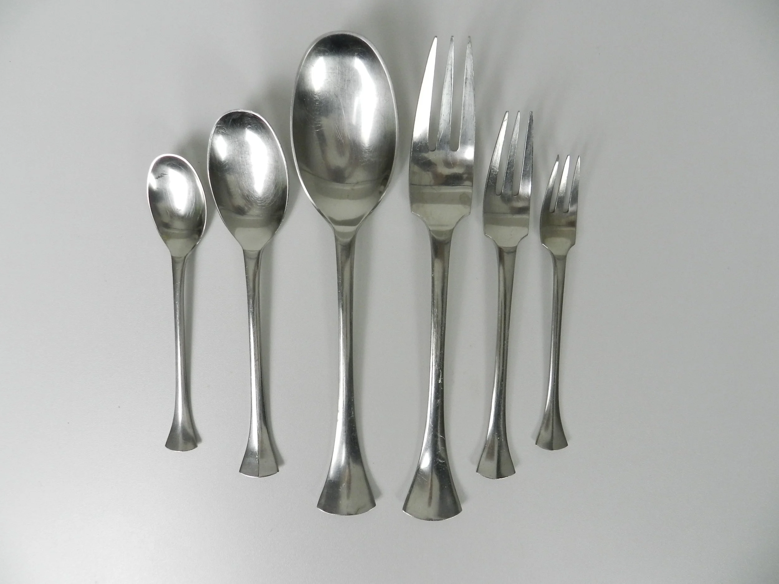 Stainless steel Thistle flatware set designed by Jens Quistgaard for Dansk. France, 1960s.