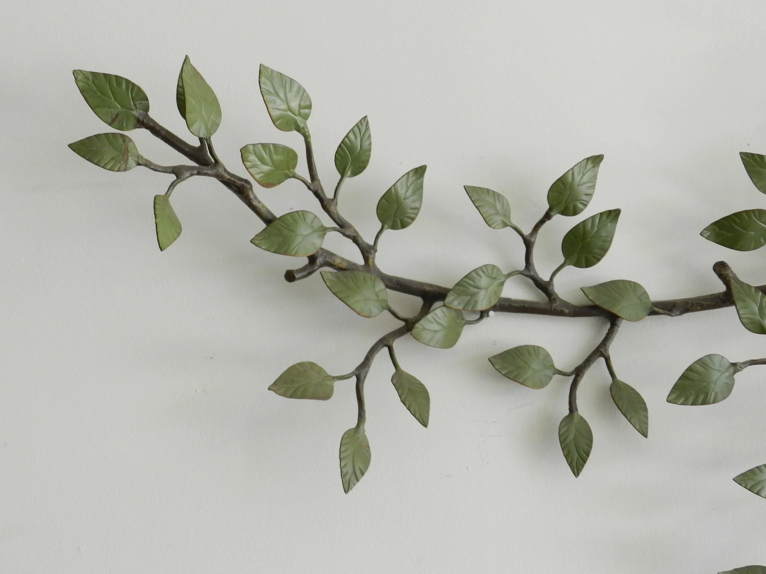 Vintage high quality wall sculpture of branch with leaves in painted metal.  circa 1940s.