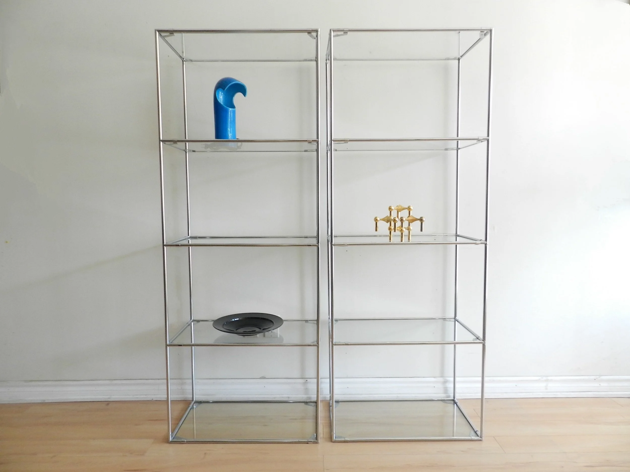 Pair of Abstracta chrome and glass modular shelf units designed by Poul Cadovius for Royal System.  Denmark, 1970s.