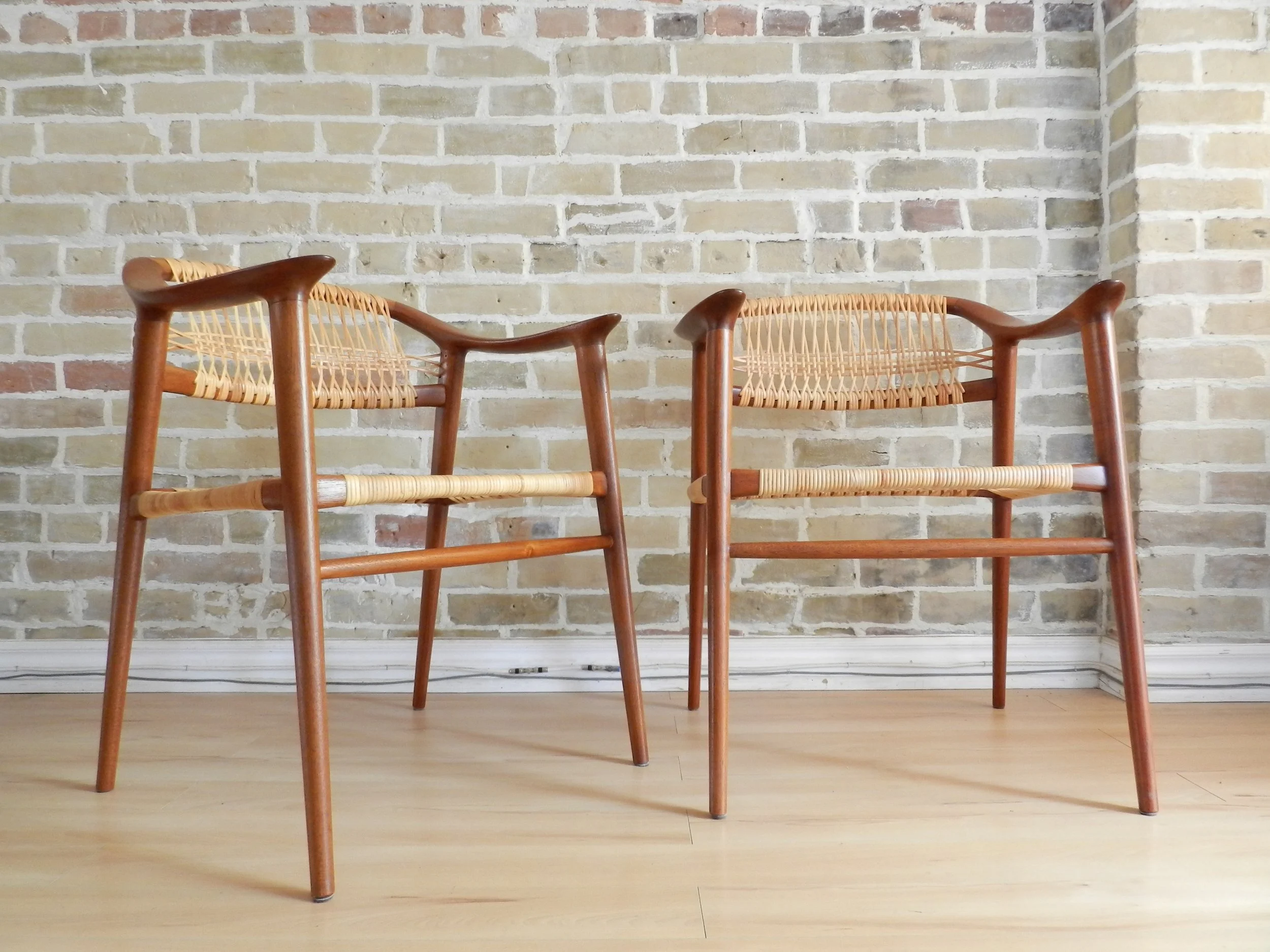 Pair of teak and cane “Bambi” arm chairs designed by Rolf Rastad and Adolf Relling for Gustav Bahus.  Norway, 1950s.