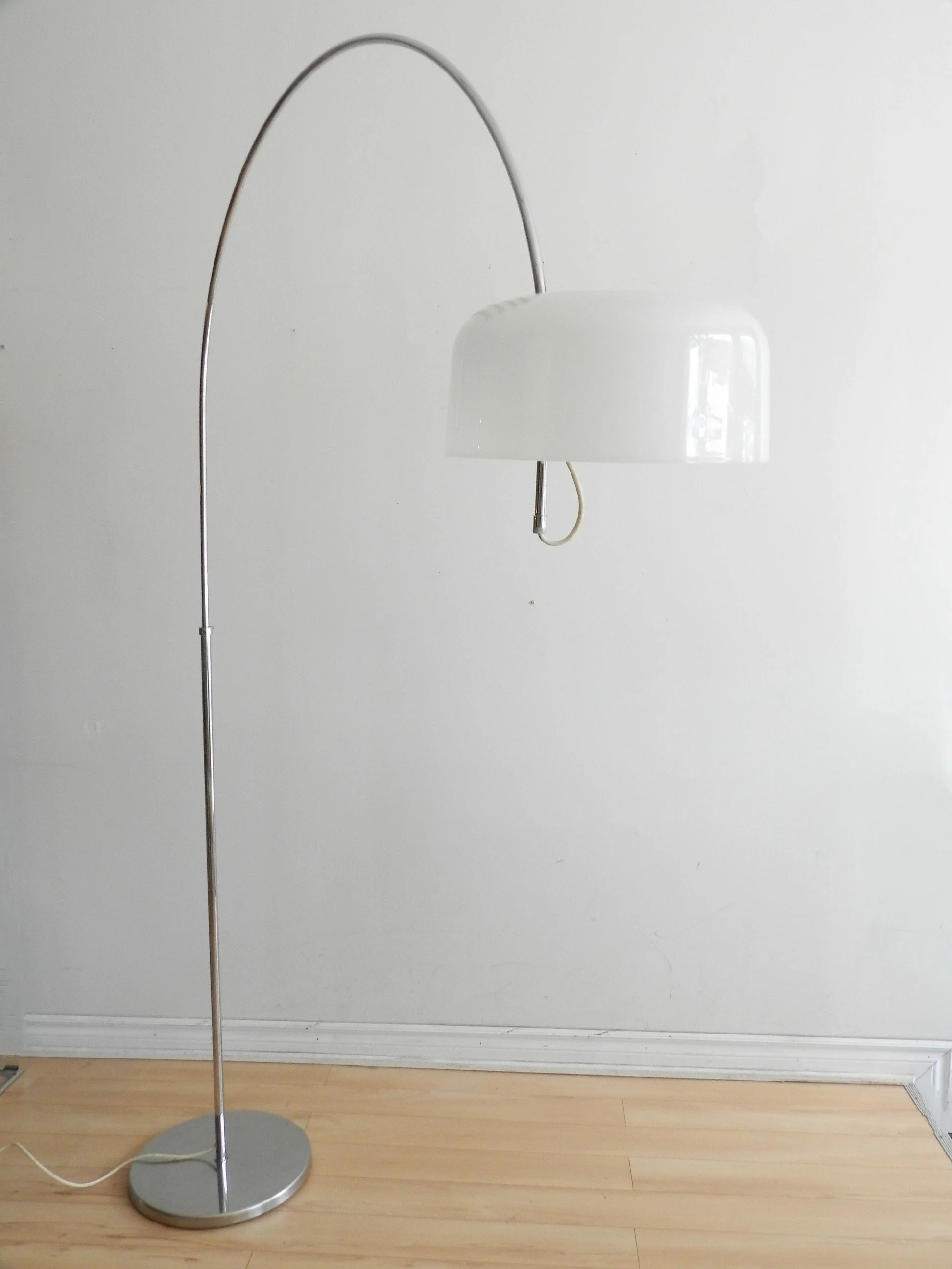 Modernist arc floor lamp by Raak. Chromed steel with acrylic shade and lucite hardware.  Netherlands, 1970s.