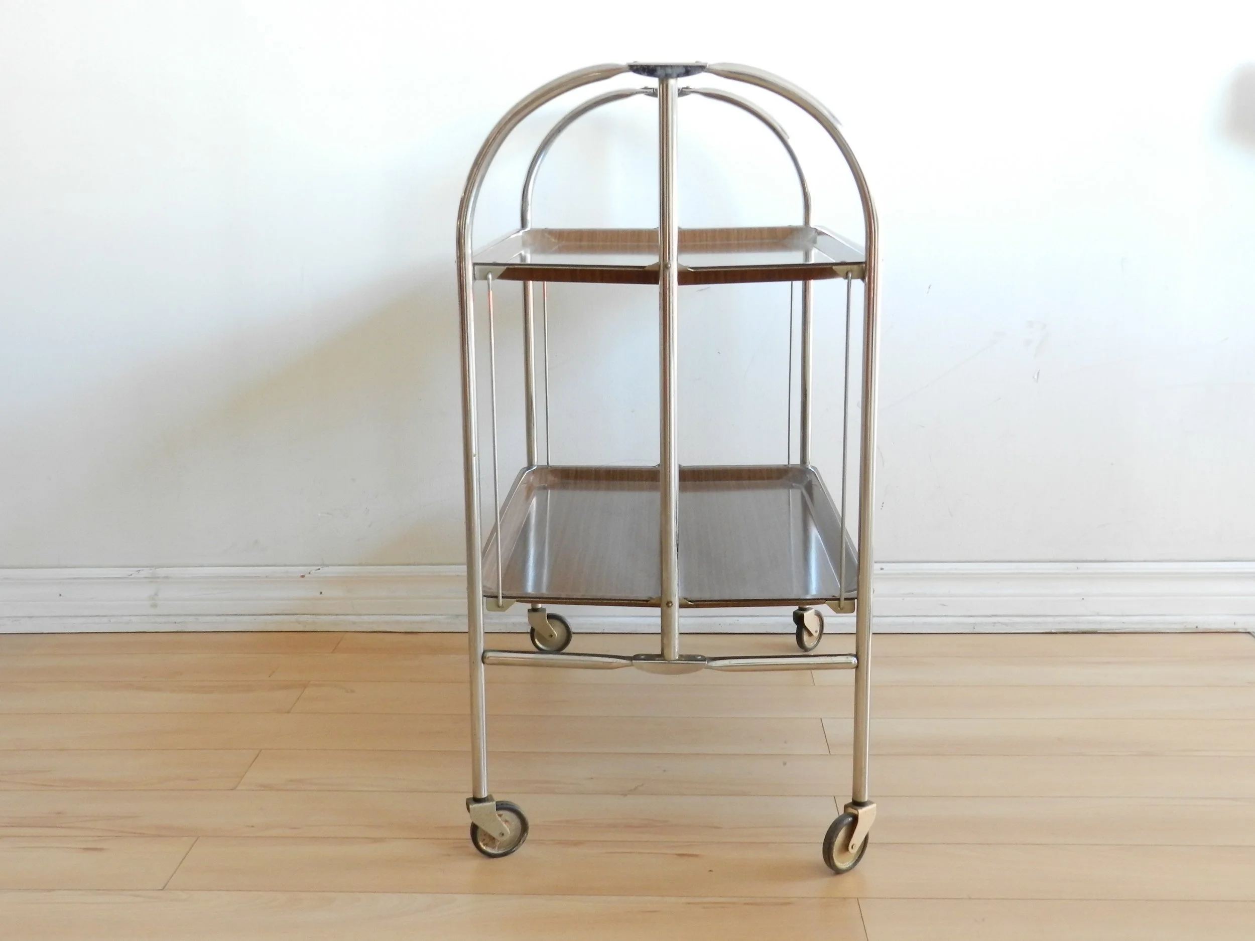Vintage folding bar cart in chrome with fromica shelves.  Germany, 1960s.