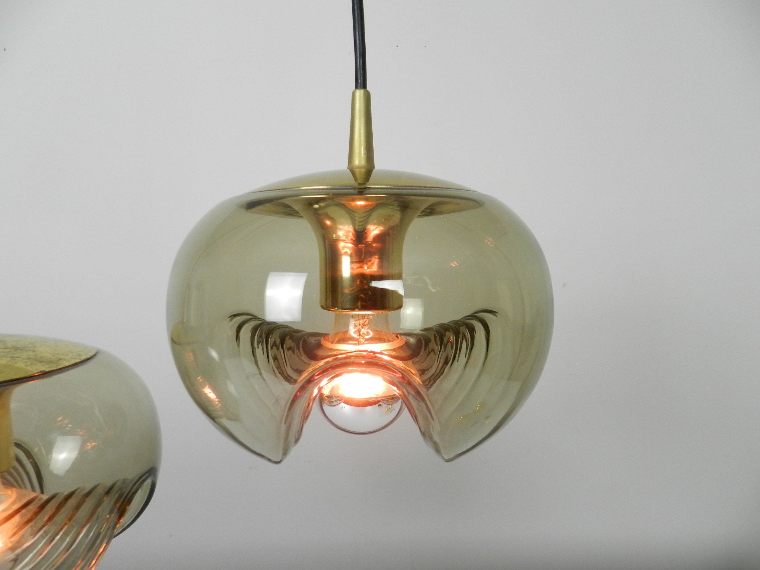 Brass and tinted glass pendant lamps by Peill and Putzler.  Germany, 1970s.