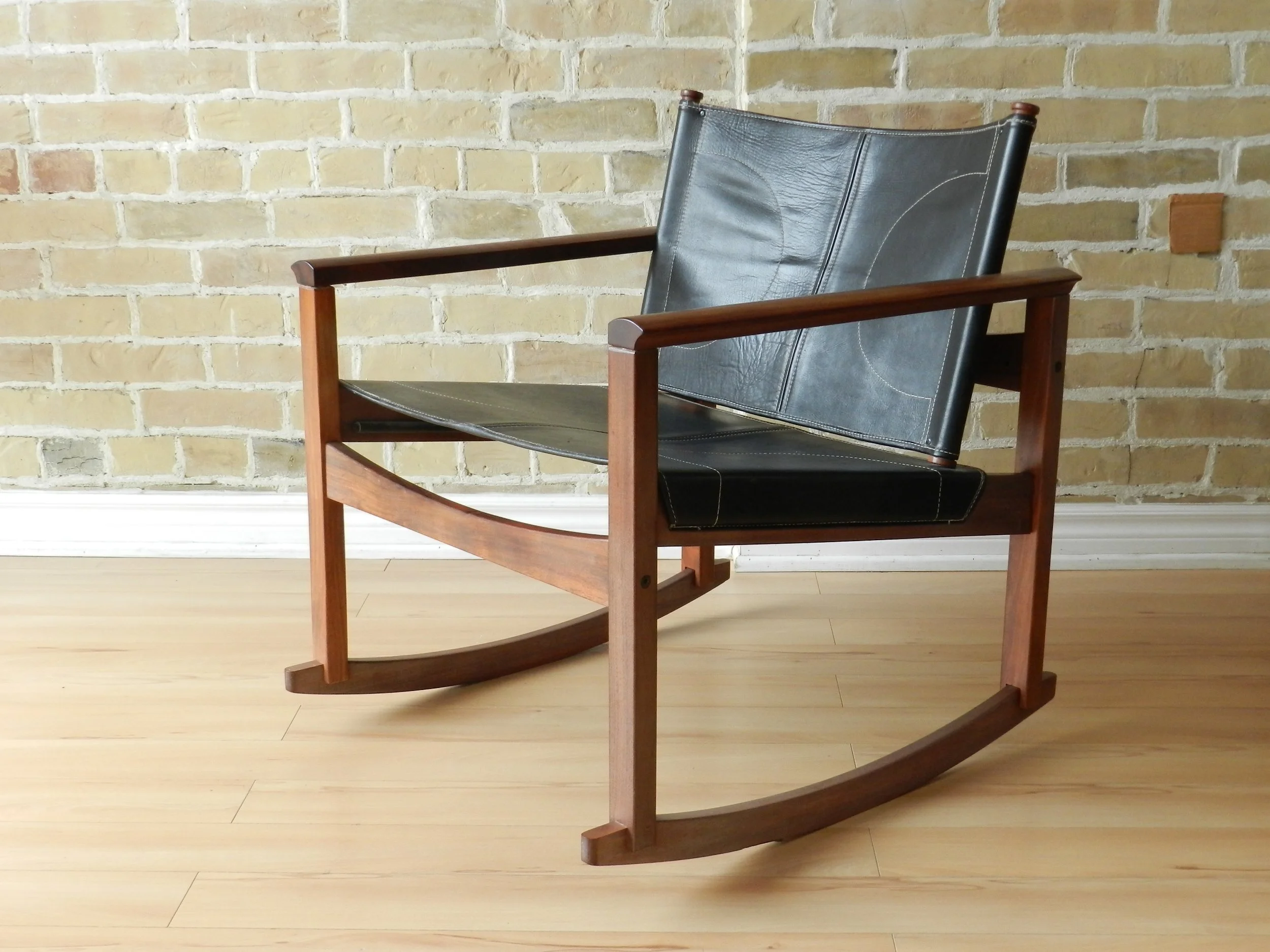 Peglev rocking chair designed by Michel Amoult for Mobilia Cotemporanea. Rosewood with leather upholstery.  Brazil, 1960s.