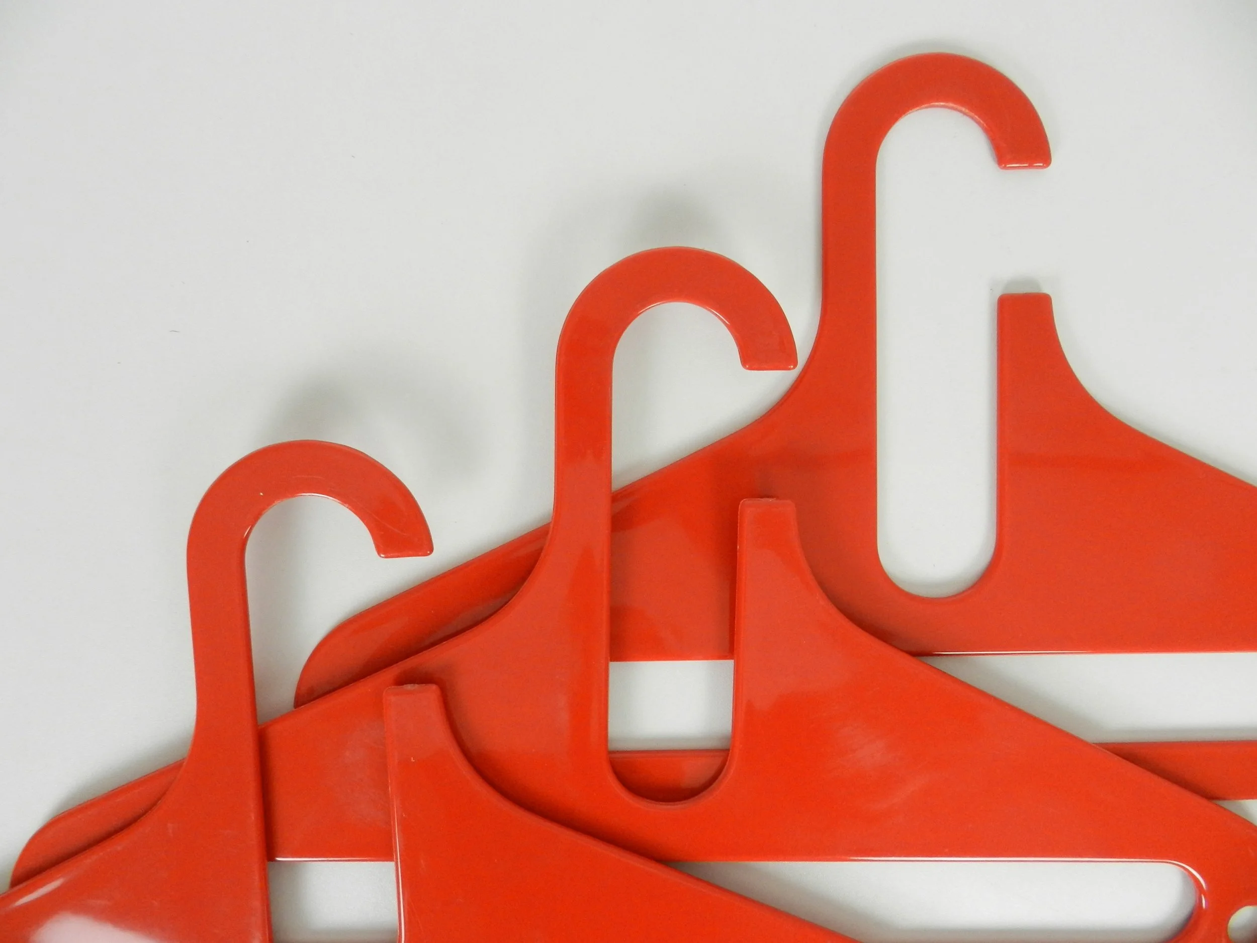 Set of 5 vintage space age plastic hangers. three designed by Karhumuovi, Finland and two designed by W.O.W., USA.  circa 1970s.