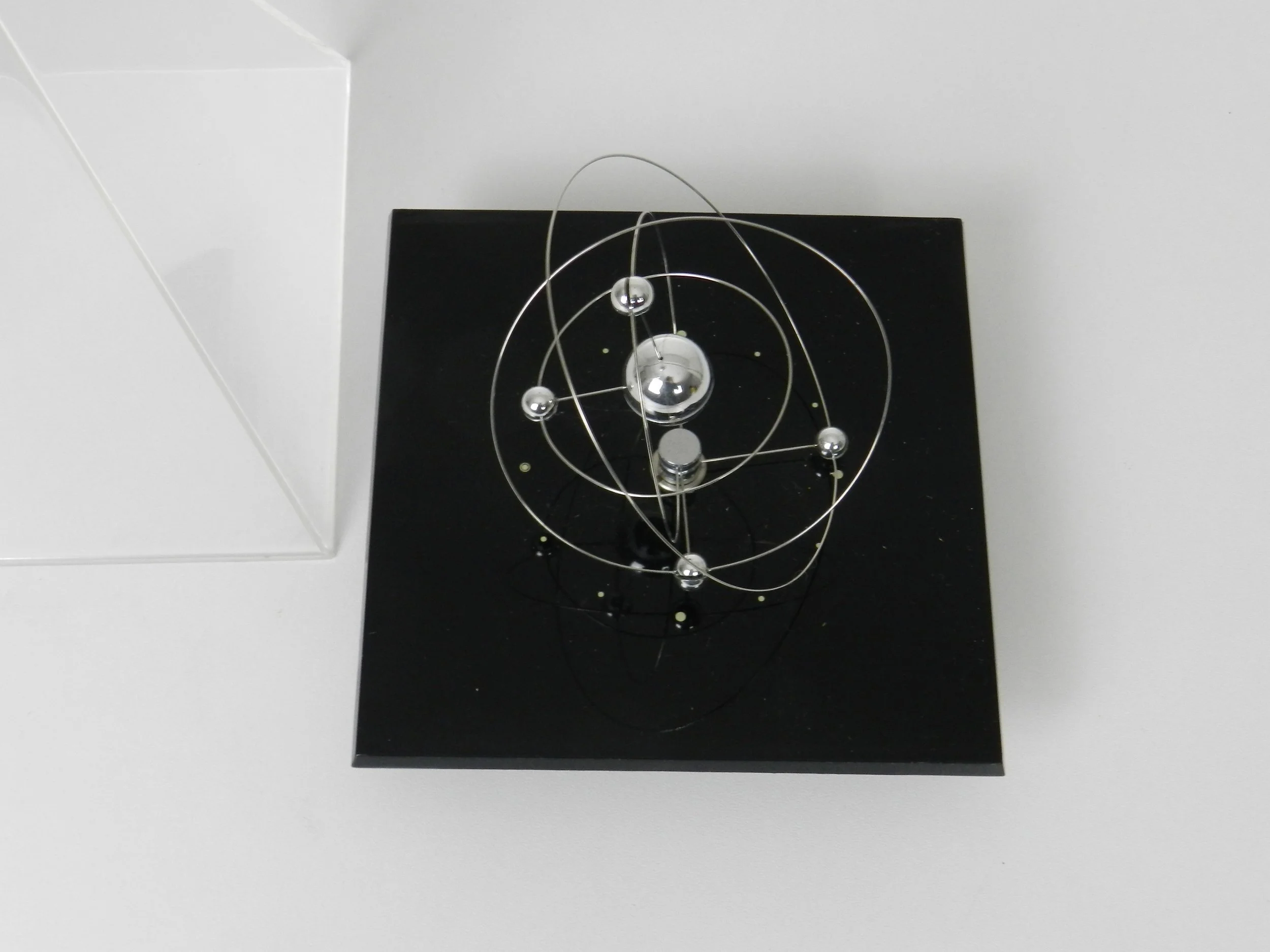 DSpace age planetary orbit clock in clear and black acrylic with chrome wires.  circa 1980s.