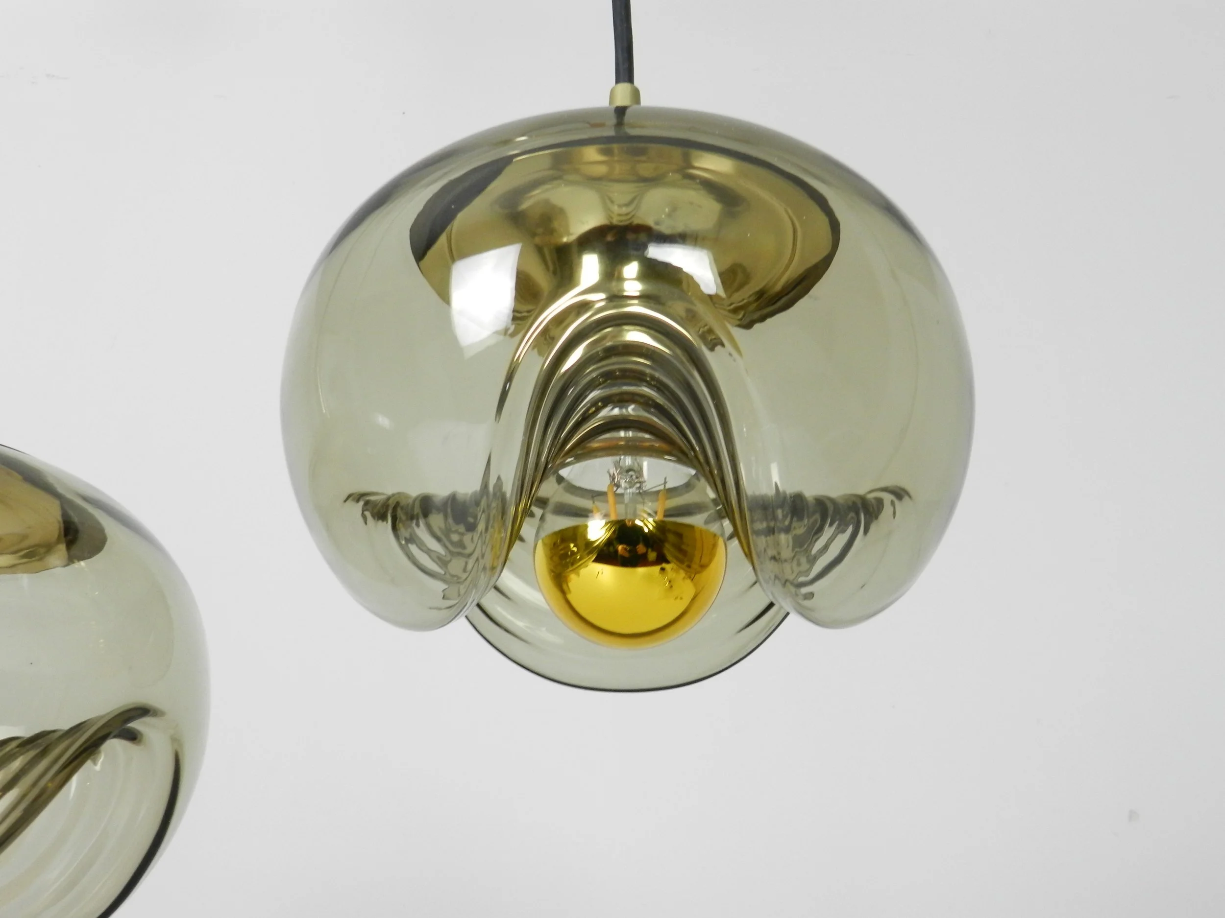 Brass and tinted glass pendant lamps by Peill and Putzler.  Germany, 1970s.