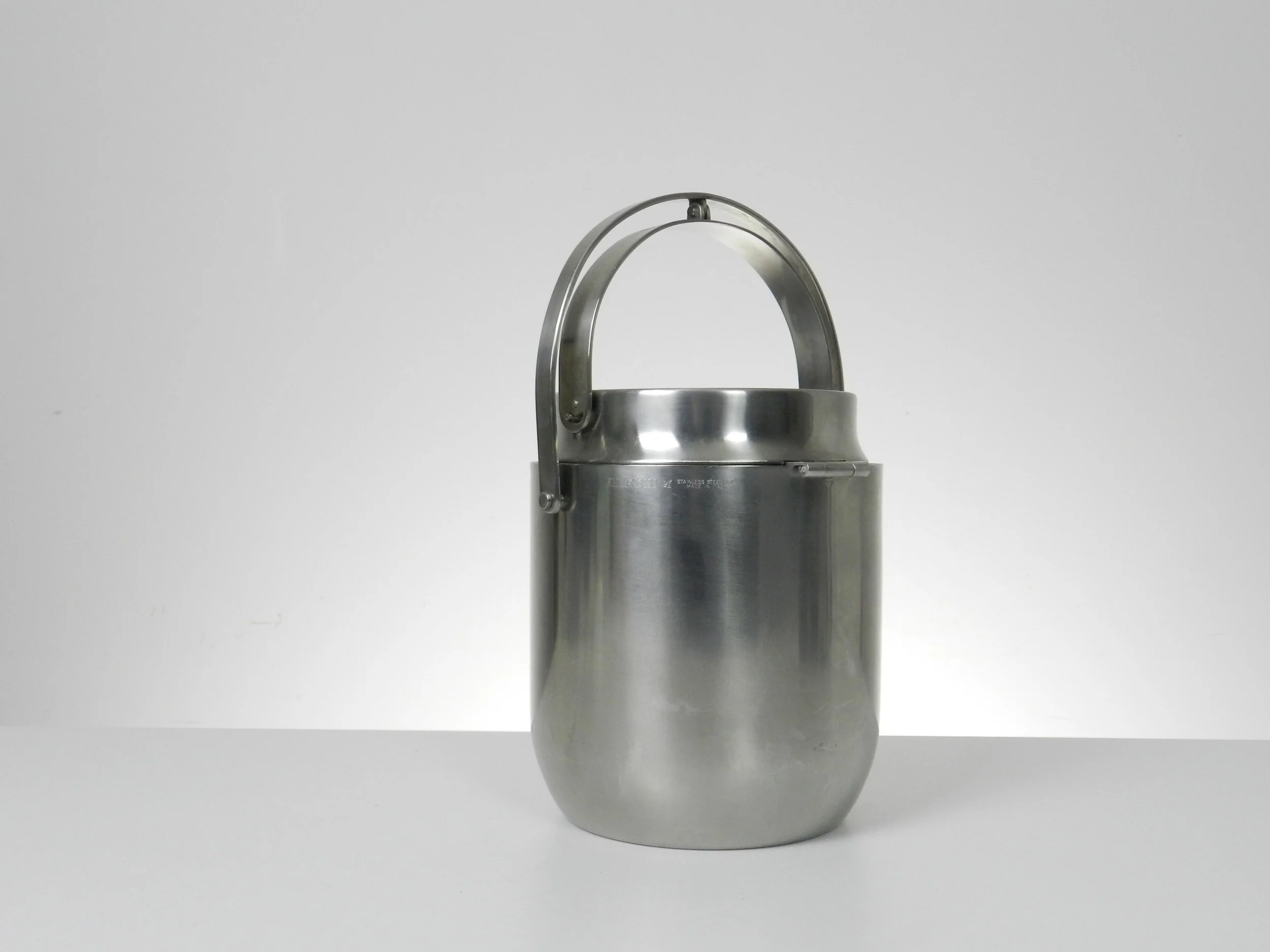 Stainless steel ice bucket with its mechanical lid, glass interior and plastic liner. Designed by Anselmo Vitale and Carlo Mazzeri for Alessi.  Italy, 1970s.