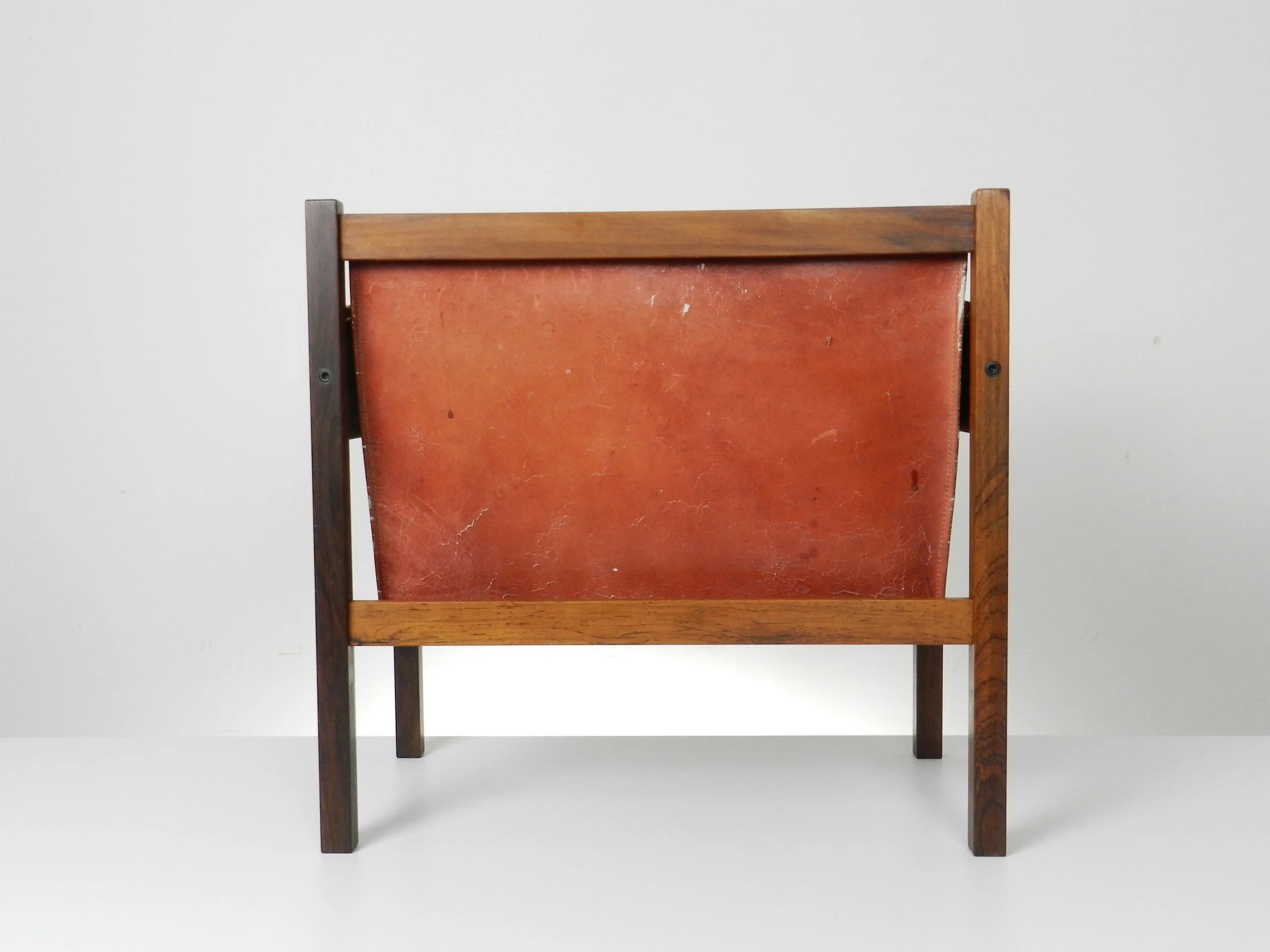 Mid century modern magazine rack in rosewood and leather designed by Torbjorn Afdal for Bruksbo.  Norway, 1960s.